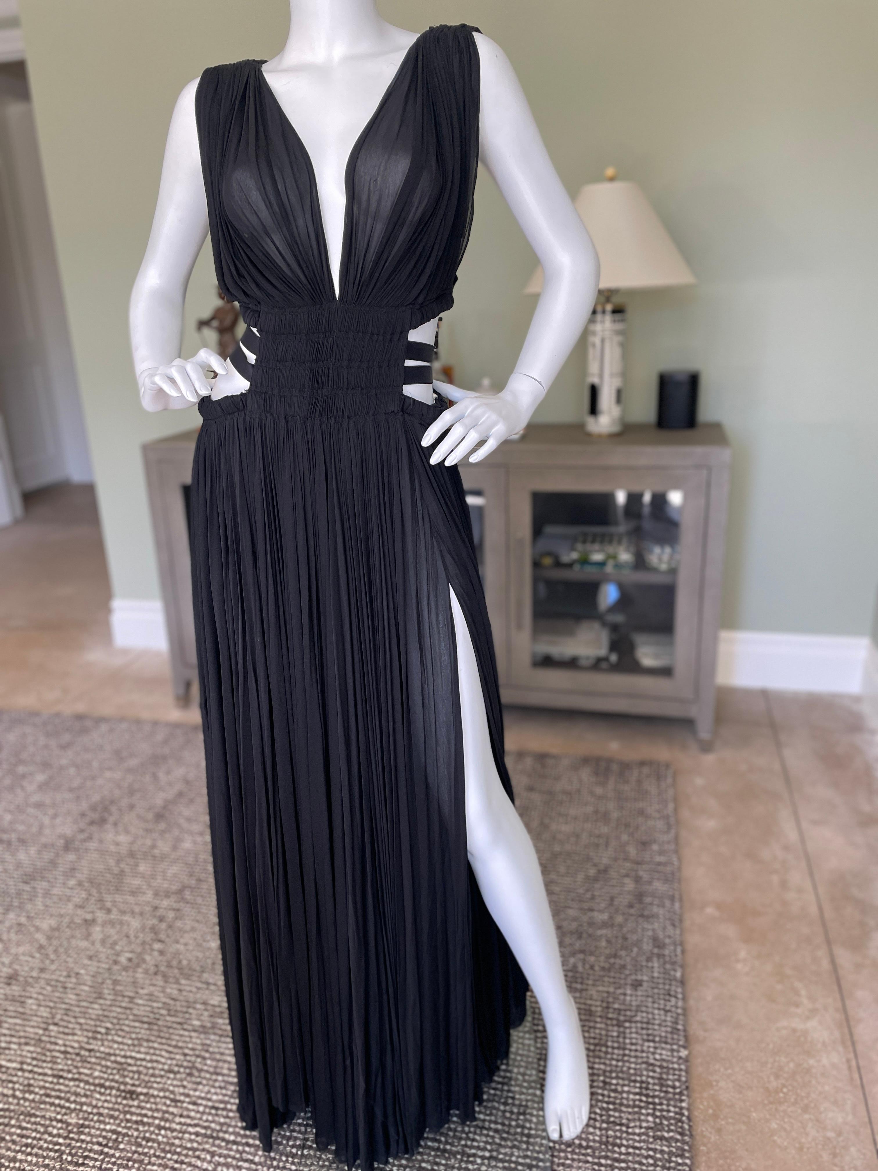 Azzedine Alaia 2004 Semi Sheer Black Pleated Goddess Gown with Side Straps.
This is the original 2004 dress , not the reissue currently in stores.
There is a snap panty closure that attaches front to back.
 Size 40
 Bust 36