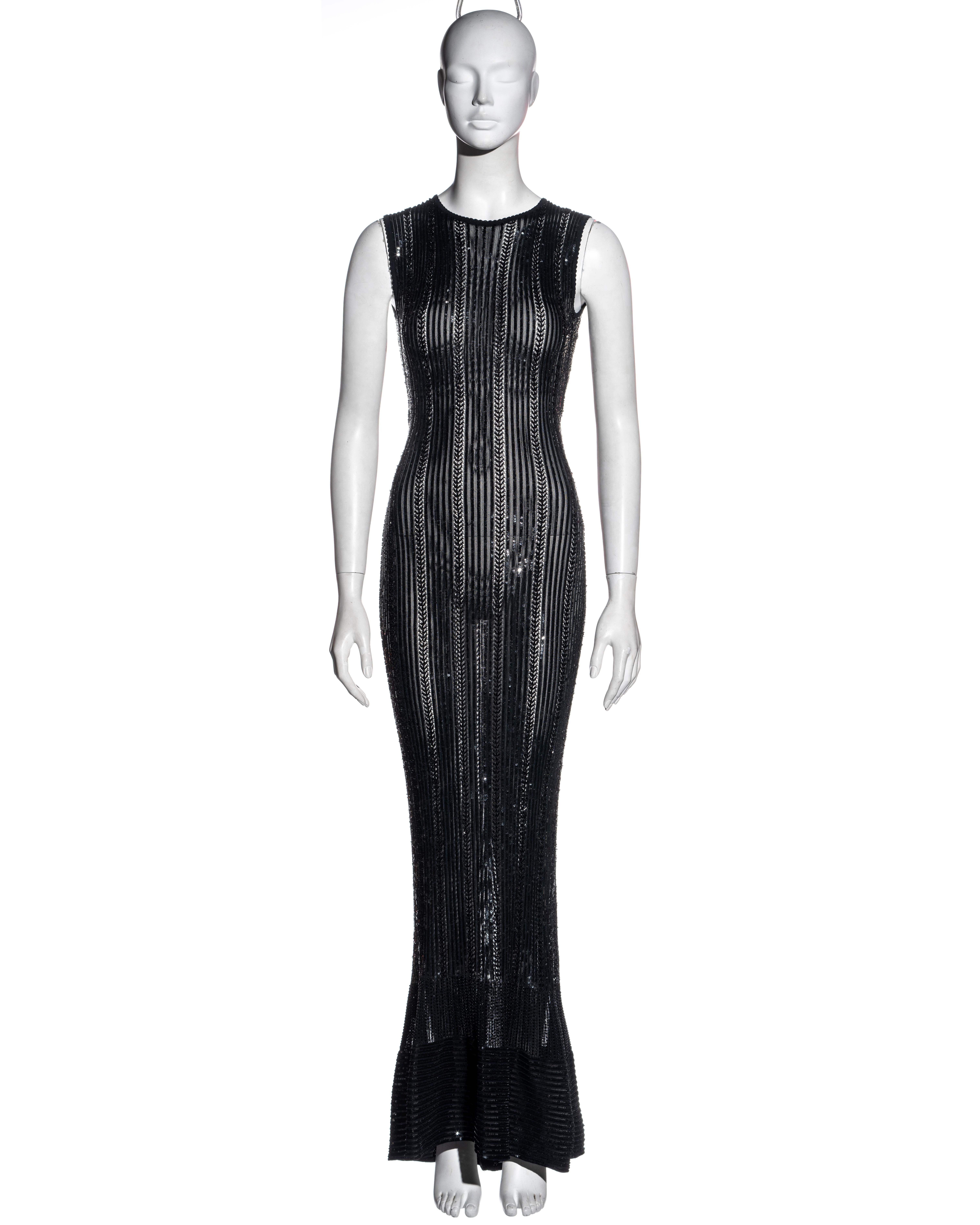 ▪ Azzedine Alaia black floor-length evening dress
▪ Bead and sequins embellished in a vertical striped pattern 
▪ Open-knit 
▪ Figure-hugging 
▪ Floor-length mermaid skirt 
▪ Size Small
▪ Spring-Summer 1996
▪ 100% Viscose 
▪ Made in Italy