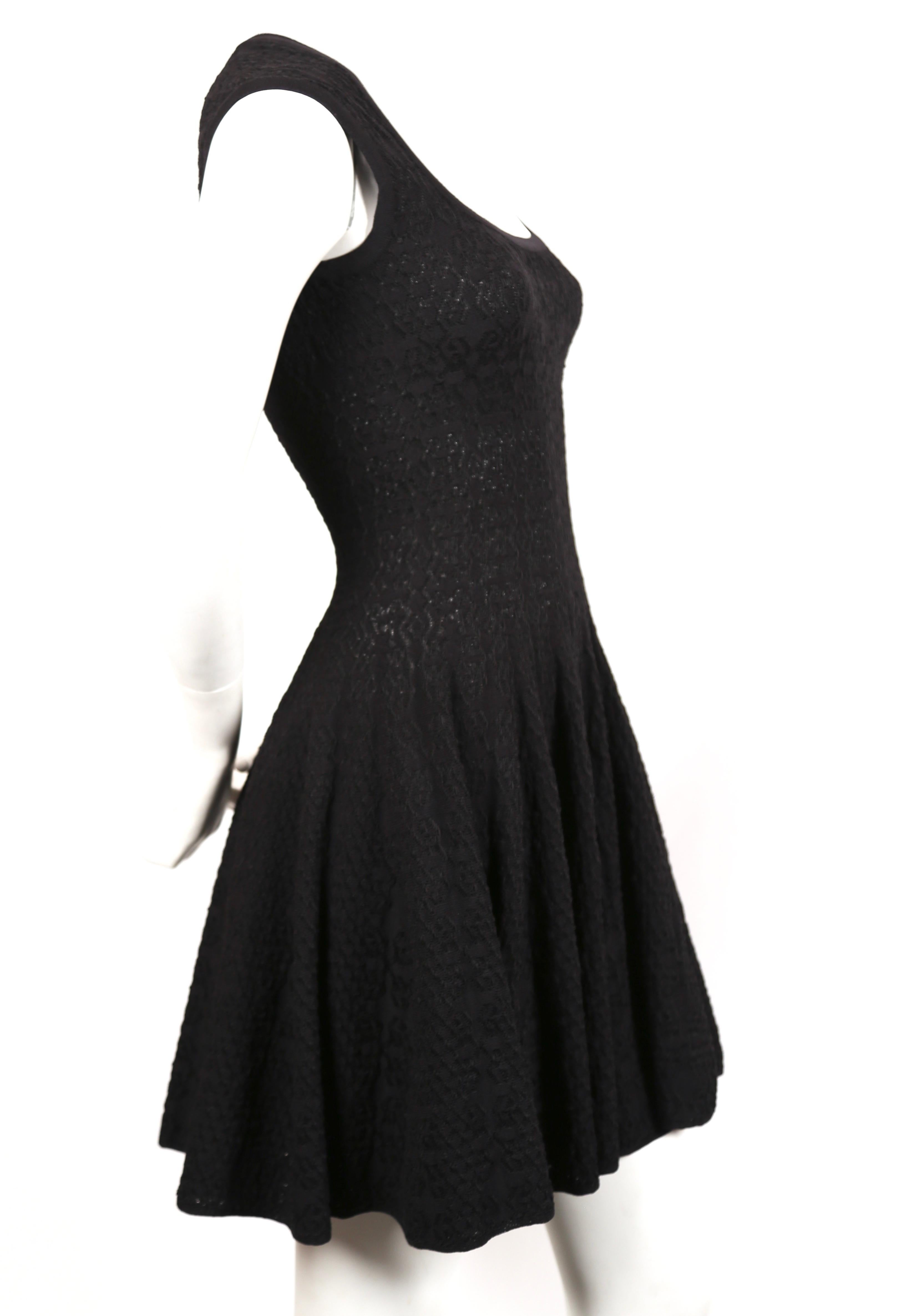 Black knit 'Muguet' dress by Azzedine Alaia. Labeled a French size 38 however this best fits a French 36. Measurements are approximately: bust 30