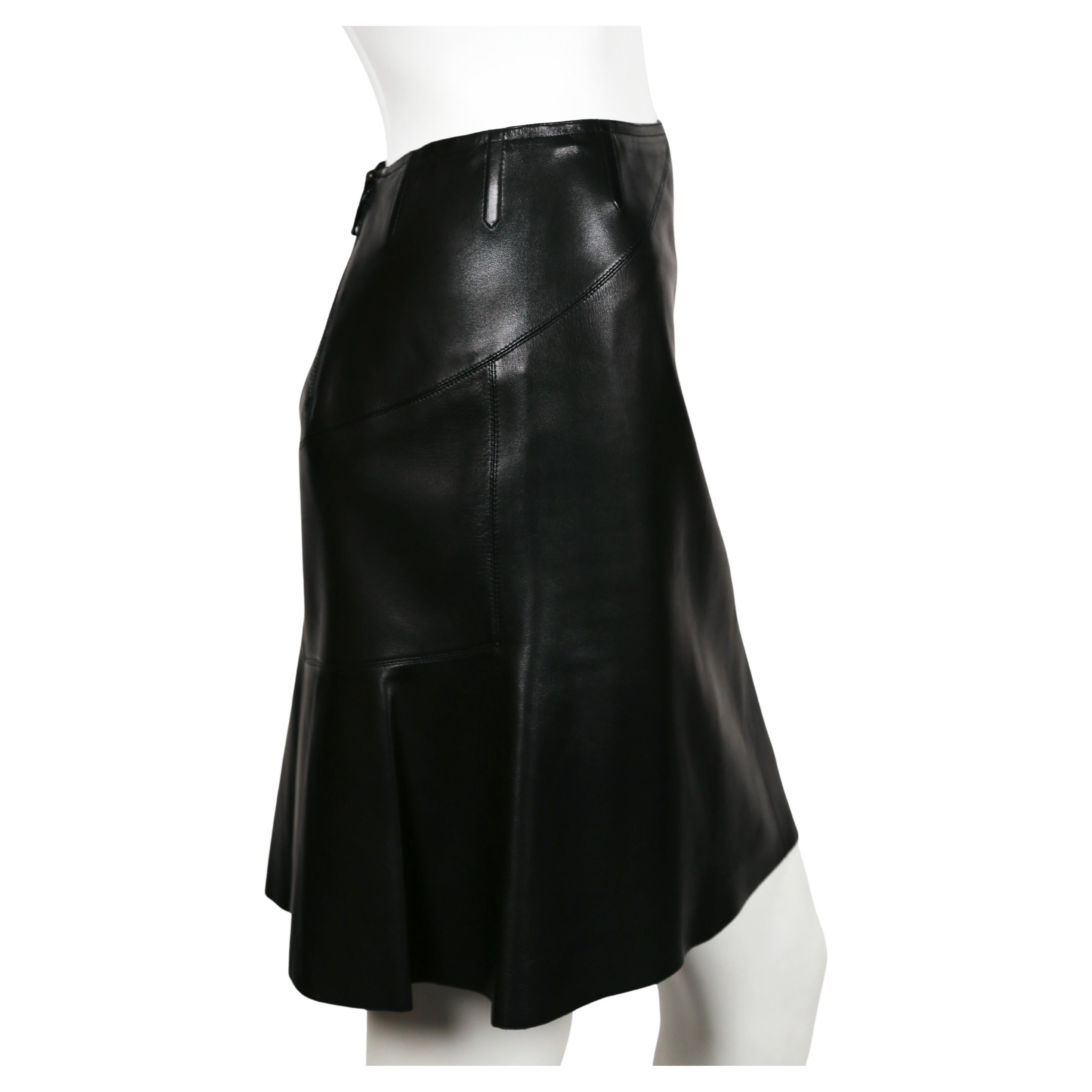 Jet-black, butter-soft leather skirt with beautiful contours and pleated hemline by Azzedine Alaia dating to the early 2000's. Very clever double zipper entry follows the line of the body. Labeled a French size 38. Approximate measurements: waist