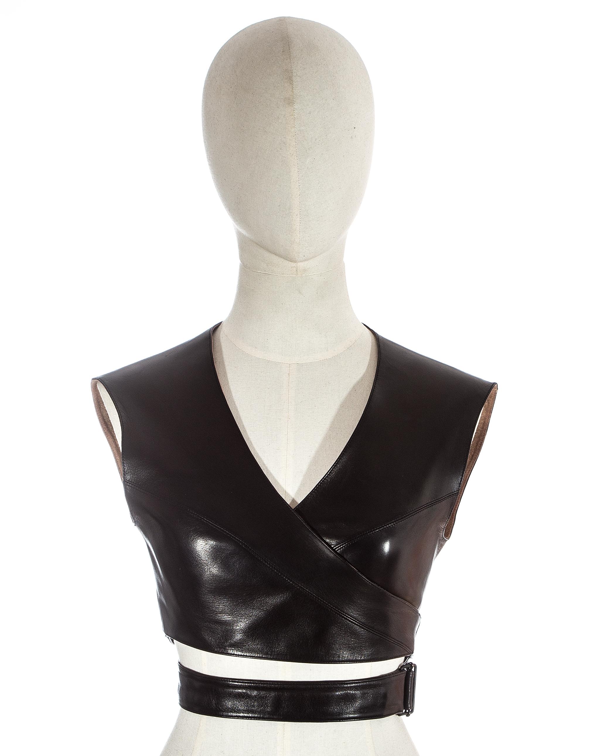 Azzedine Alaia; black leather wrap bra top, wraparound design, ties at the waist for an adjustable fit. 

Fall-Winter 1983
