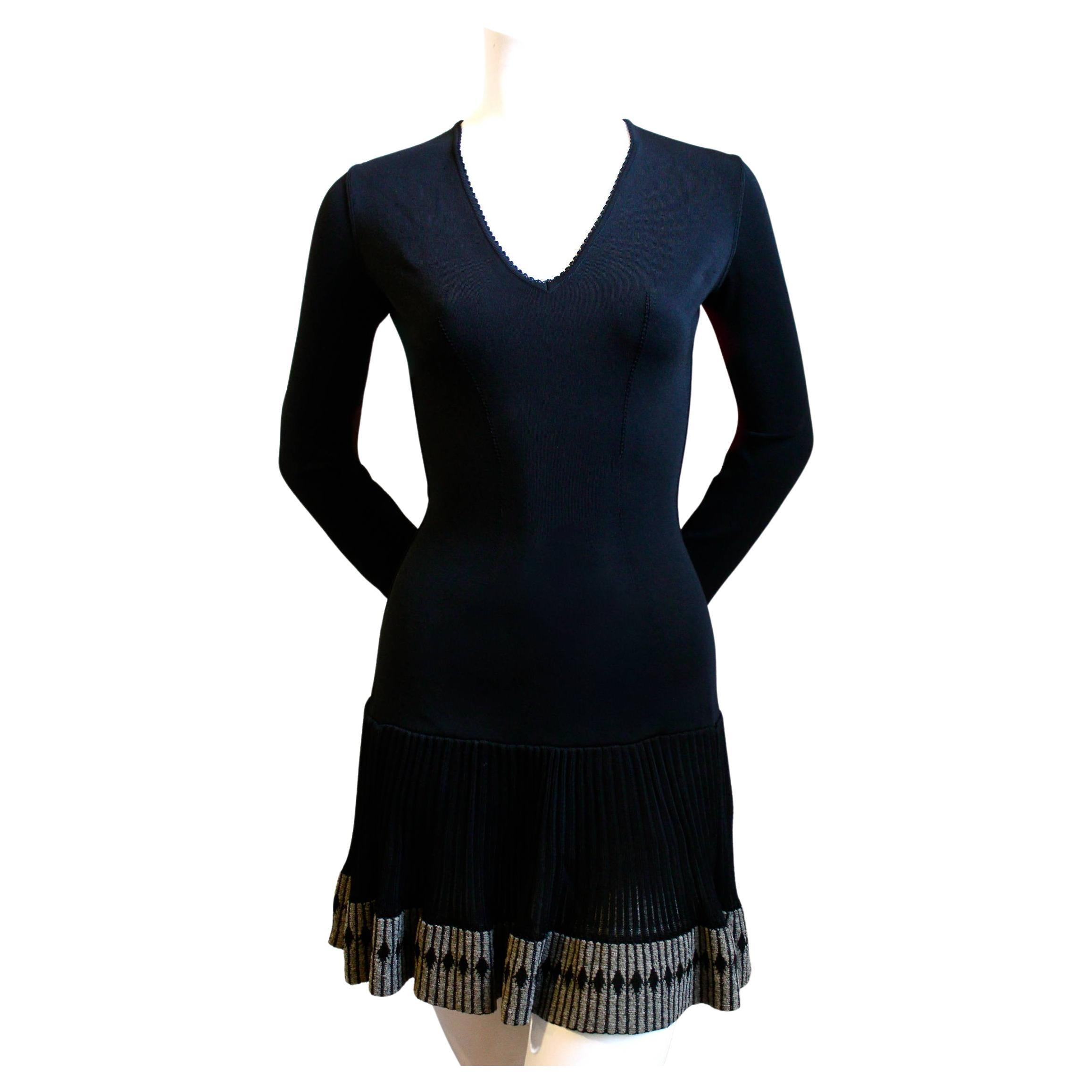 Very rare, jet black knit mini dress with scalloped trim and semi sheer skirt with  decorative diamond embroidered hemline from Azzedine Alaia dating to the early 1990's, Dress is labeled a size S. Zips up back with bodysuit for modesty (snap