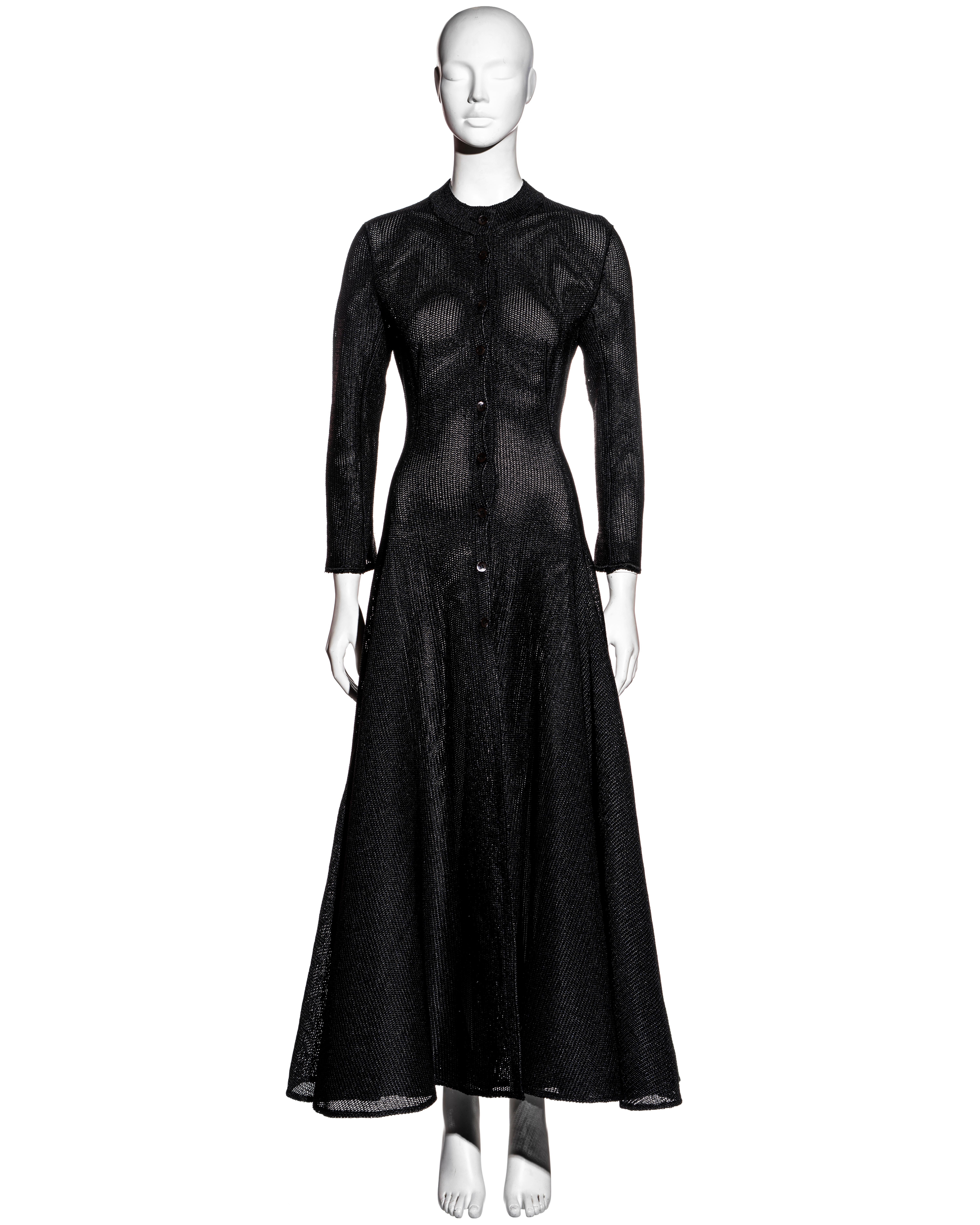 ▪ Azzedine Alaia black raffia maxi dress
▪ Front button fastenings 
▪ Long sleeves with flared cuffs 
▪ Structured a-line maxi skirt 
▪ Curved seams at the bodice 
▪ Drop waist 
▪ 100% Rayon
▪ Size Small
▪ Spring-Summer 1996