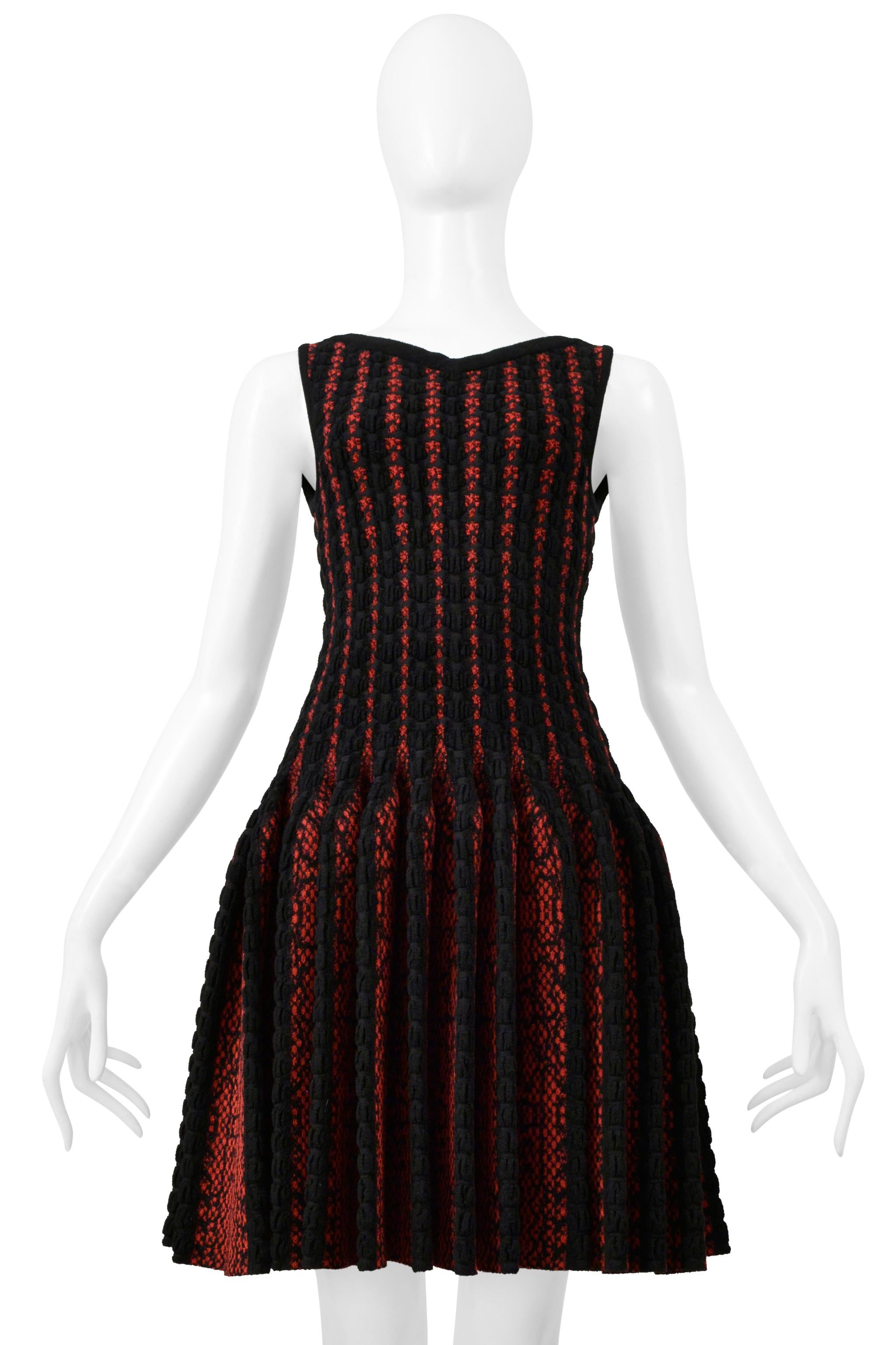 Resurrection Vintage is excited to offer a vintage Azzedine Alaia black and red fancy knit chenille sweetheart dress featuring an abstract graphic print, sleeveless body, fitted torso, pleated circle skirt, and a center-back zipper.  

Alaia