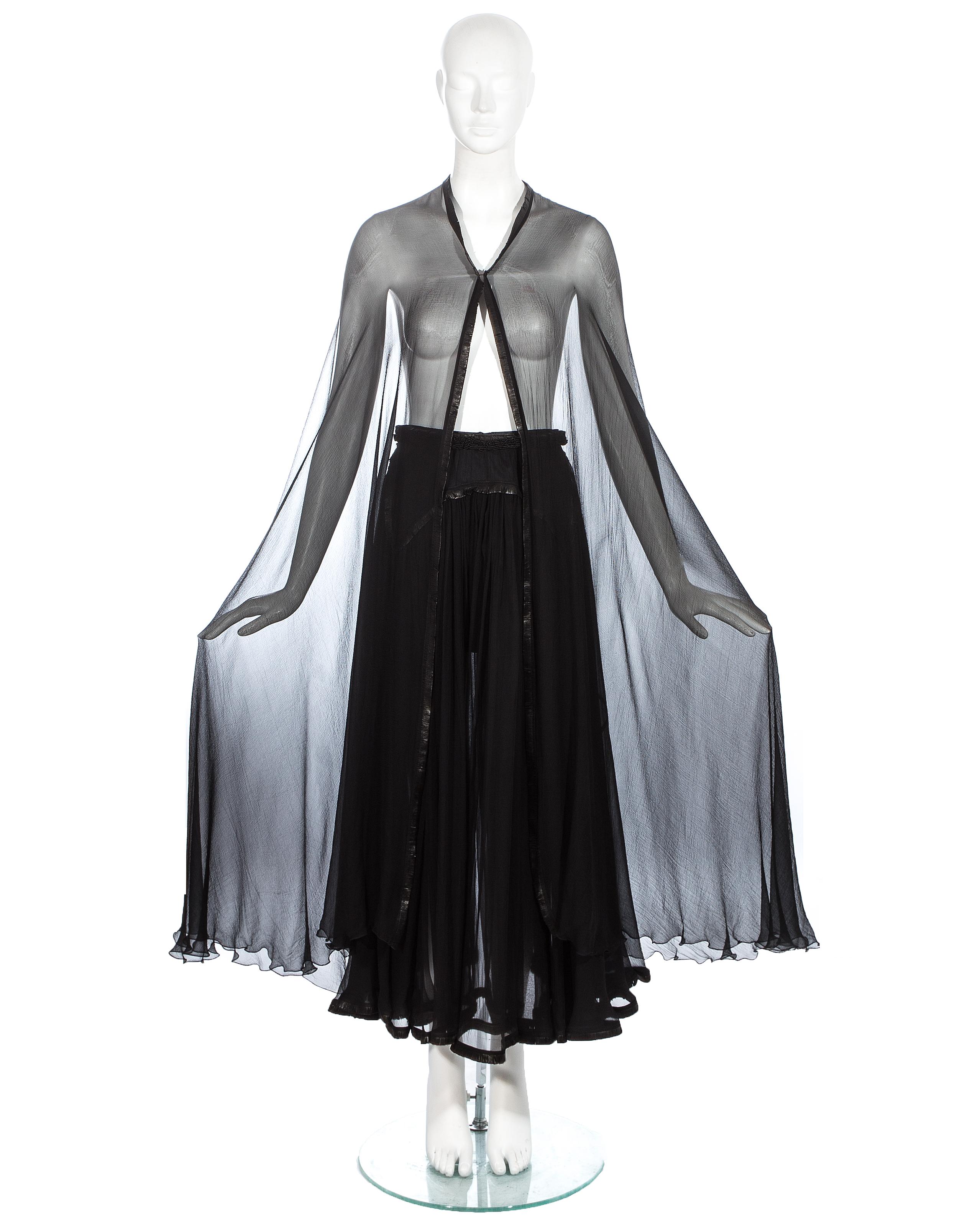 Azzedine Alaia couture black silk chiffon cape and skirt with leather fringed trim. Comes with silk shorts to wear underneath. 

c. 1994