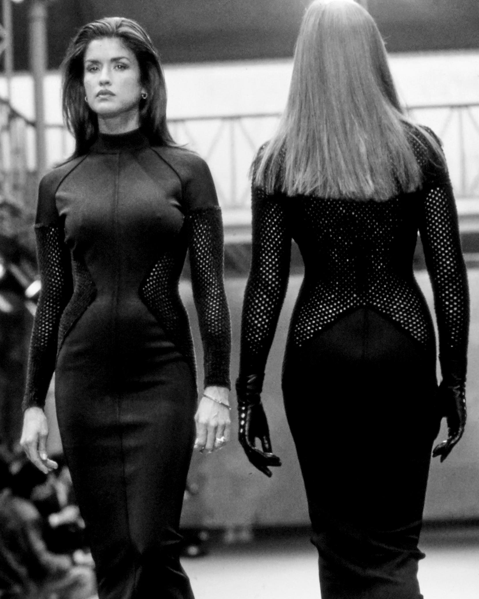 Azzedine Alaia black viscose above-the-knee figure hugging dress with chenille net panels, turtle neck and zip fastening.

Fall-Winter 1989
