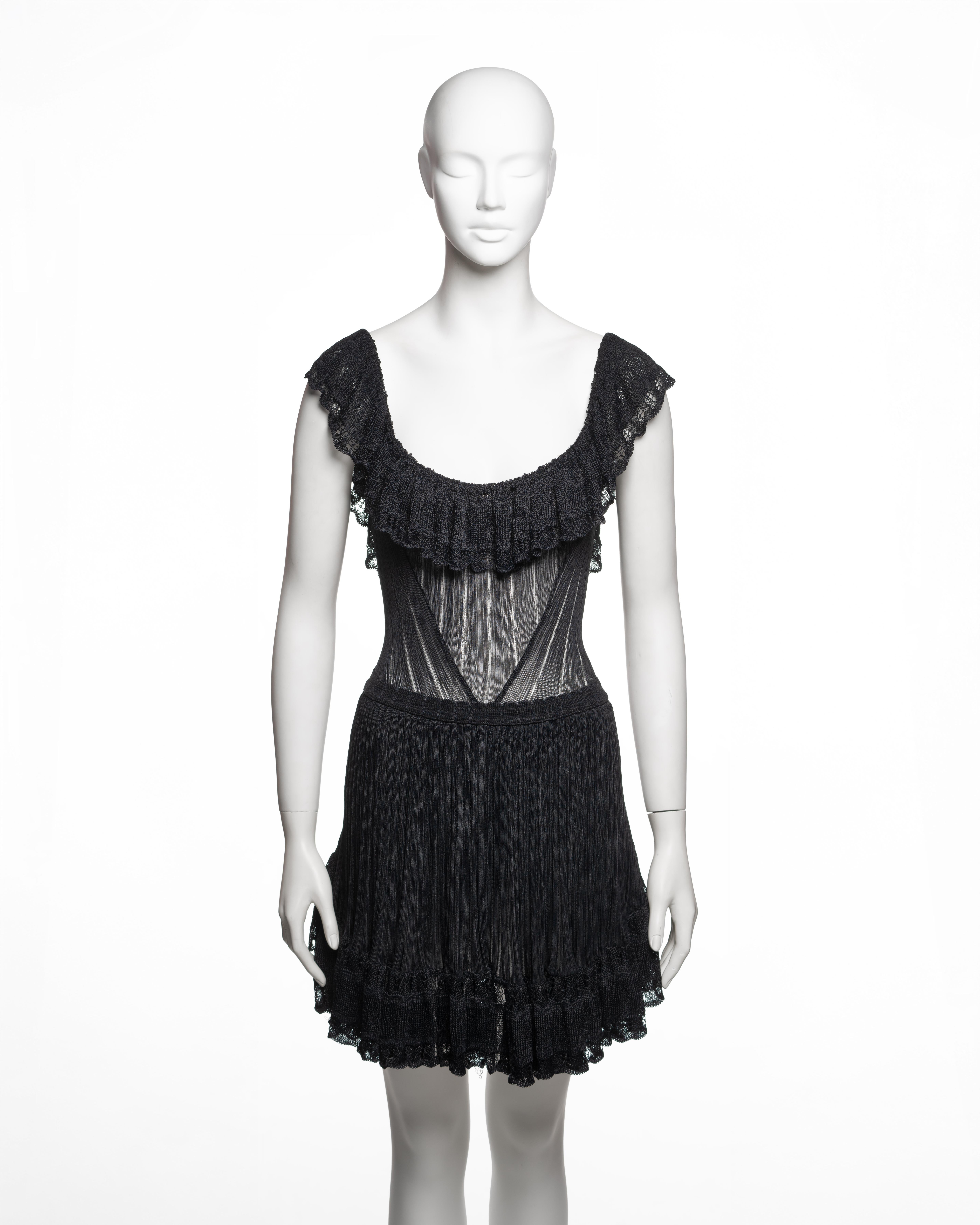 This black dress from Azzedine Alaïa’s Spring-Summer 1992 collection is constructed from fine-gauge viscose knit. The bodice features a semi-sheer ribbed knit with an integrated bodysuit providing coverage and structure. The neckline is low and