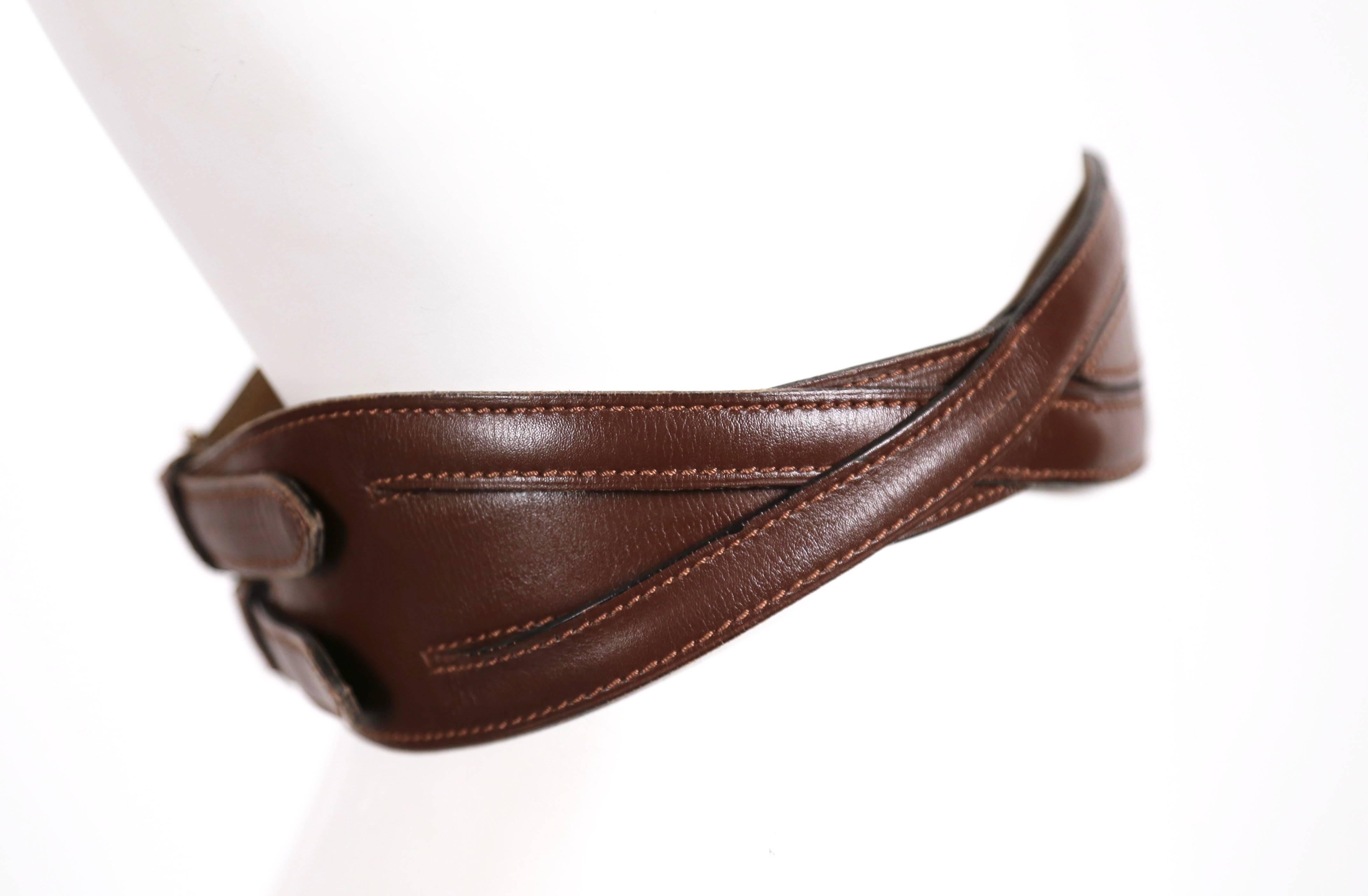 Rich brown leather belt with brass hardware designed by Azzedine Alaia dating to fall of 1990. Labeled a French size 70. Fits a 24-26