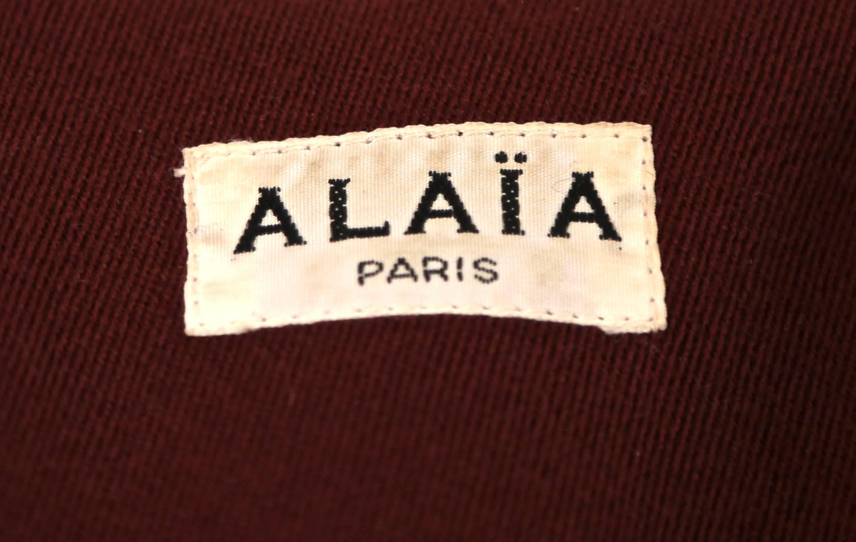 Women's or Men's Azzedine Alaia burgundy gabardine coat with wrap around pockets, 1980s 