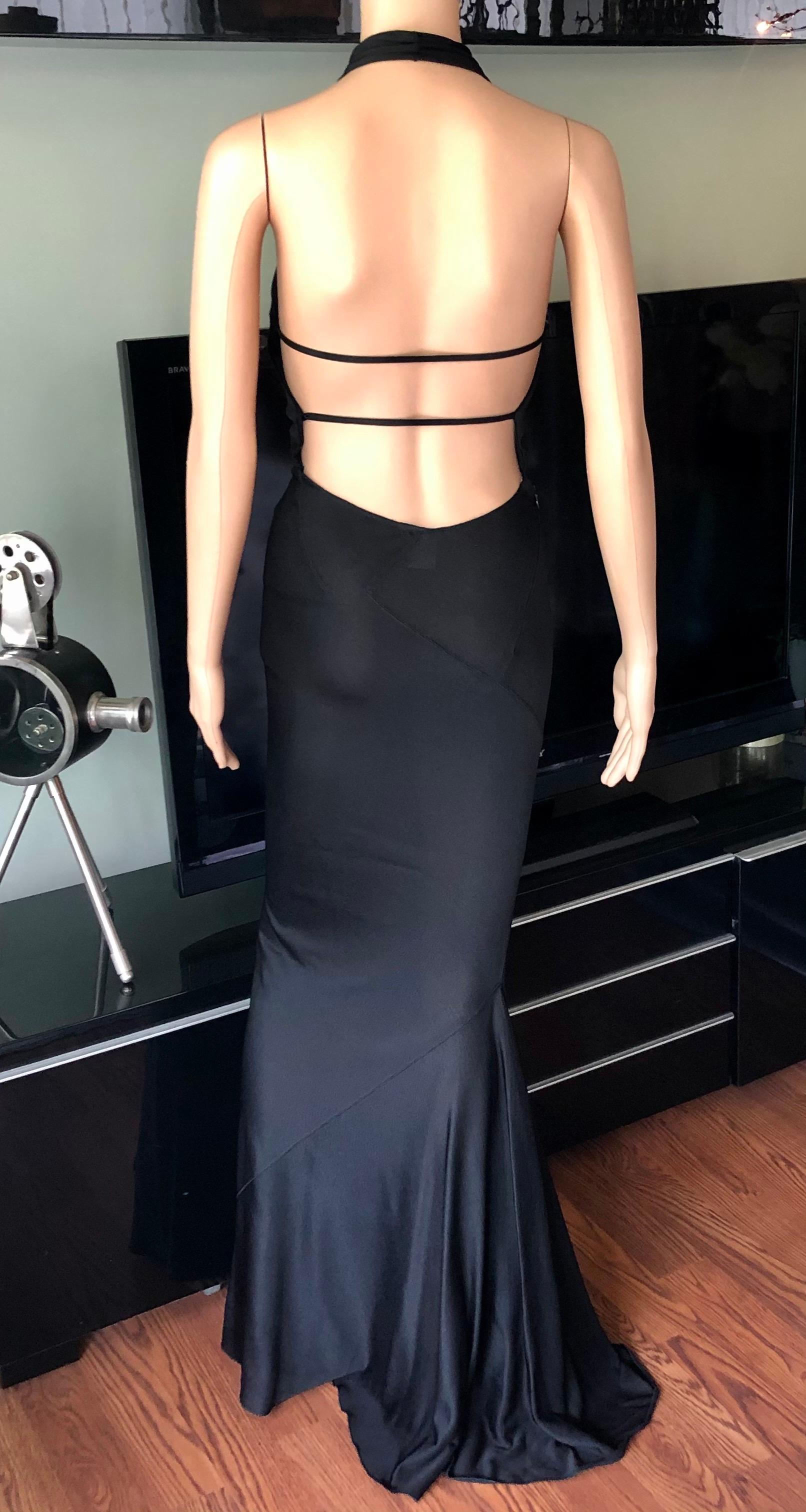 Azzedine Alaïa 2001 Vintage Halter Backless Black Gown Maxi Dress Size M

Alaïa black maxi dress featuring halter neckline, open back. flared hem with train and concealed zip closure at side. Please note bra pads has been added, could be easily