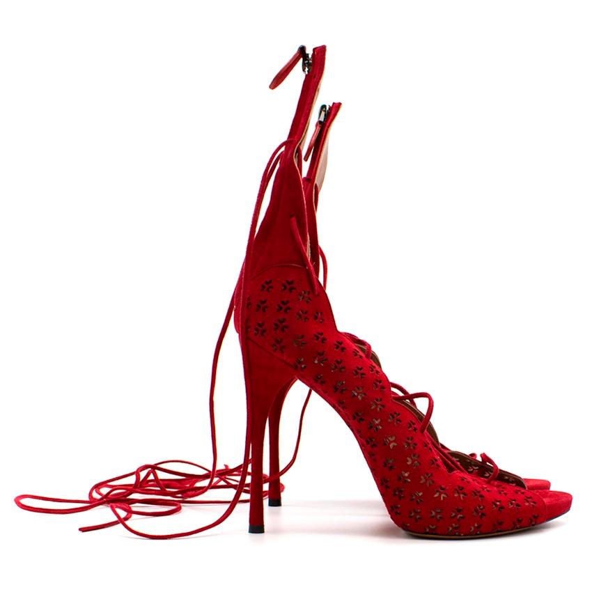 Red Suede laser cut perforated heeled sandals with ties at ankle and zip fastening along back.

Please note, these items are pre-owned and may show signs of being stored even when unworn and unused. This is reflected within the significantly reduced