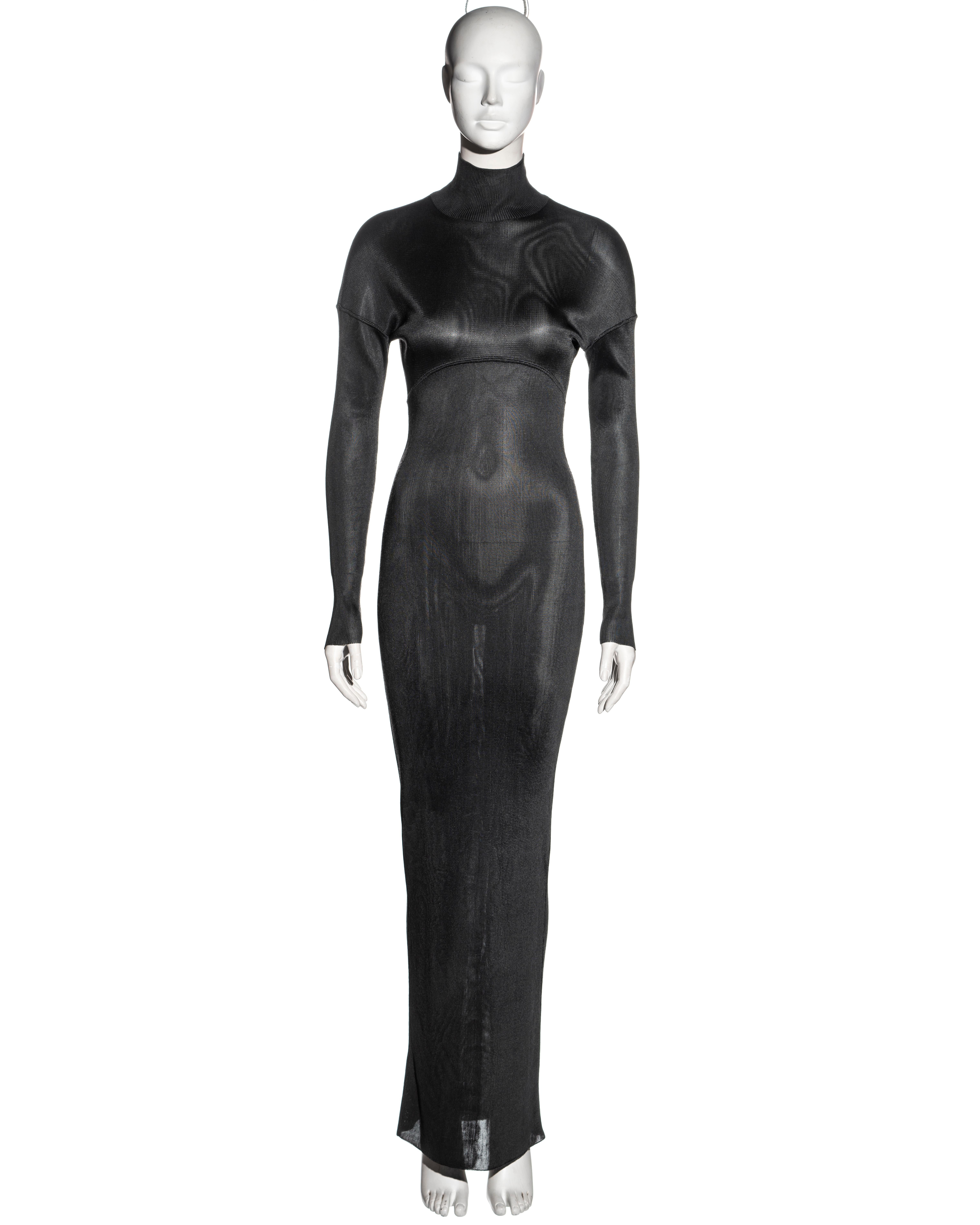 ▪ Azzedine Alaia floor-length dress
▪ Charcoal acetate knit 
▪ Figure-hugging 
▪ Long sleeves 
▪ Turtle-neck 
▪ Size Small
▪ Fall-Winter 1986
▪ 100% Acetate 
▪ Made in Italy