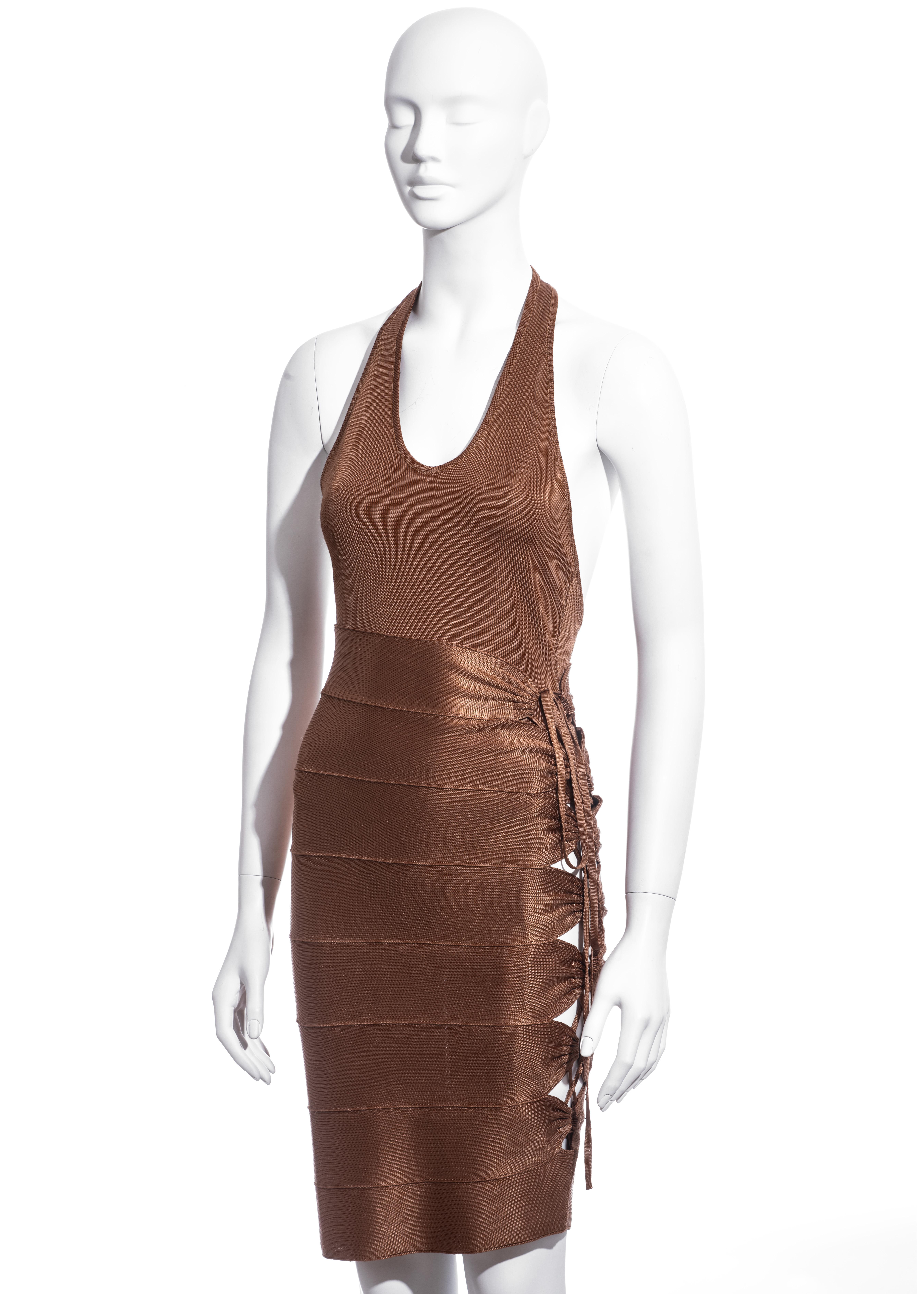▪ Azzedine Alaia copper bandage skirt and bodysuit 
▪ 100% Acetate  
▪ Eight connecting panels  
▪ Skin bearing lace-up string fastening  
▪ Halterneck bodysuit
▪ Size Small 
▪ Spring-Summer 1986