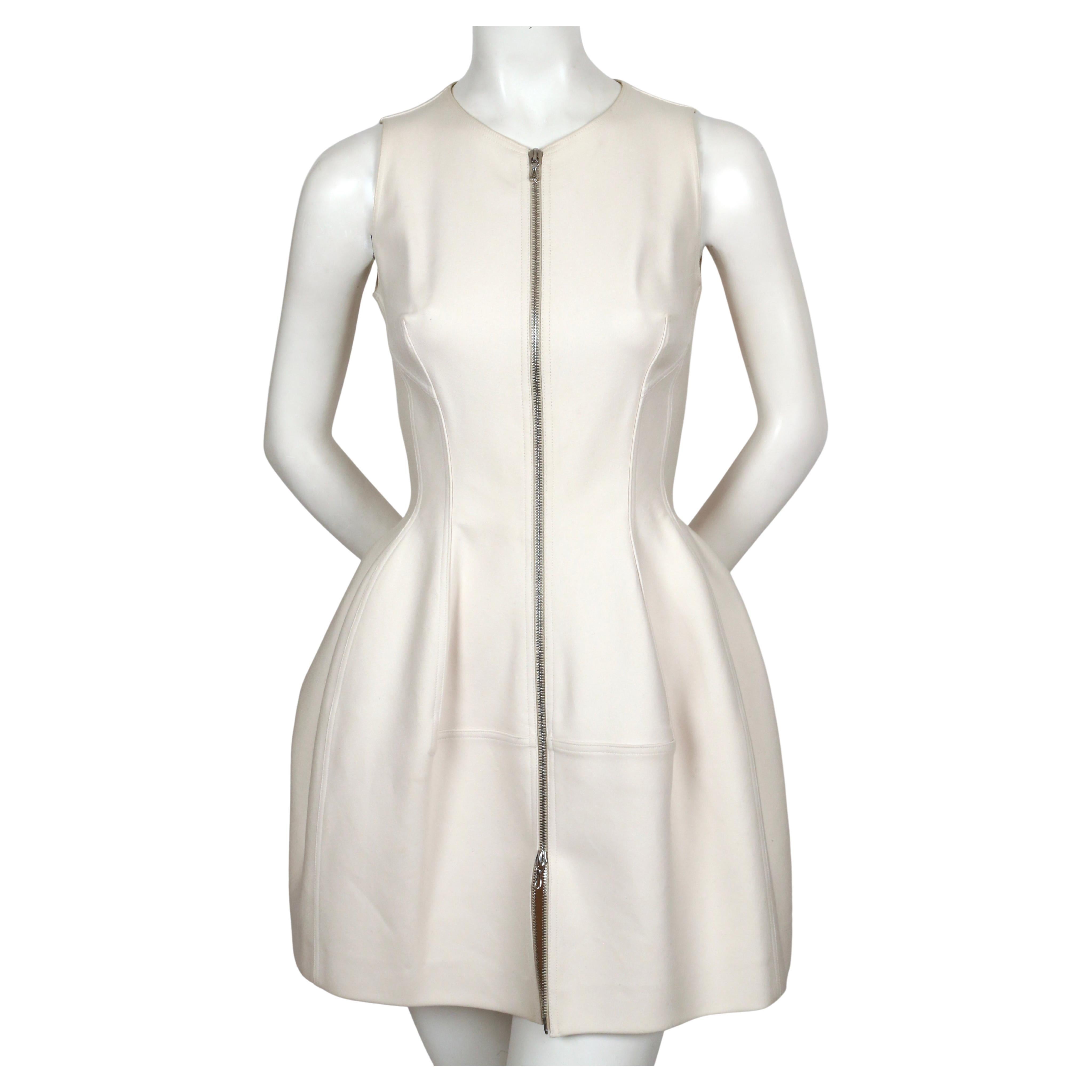 Gorgeous, cream, tulip shaped dress with silver toned two-way zipper from Azzedine Alaia. No size is indicated however it best fits a size 4 or slim 6 (33