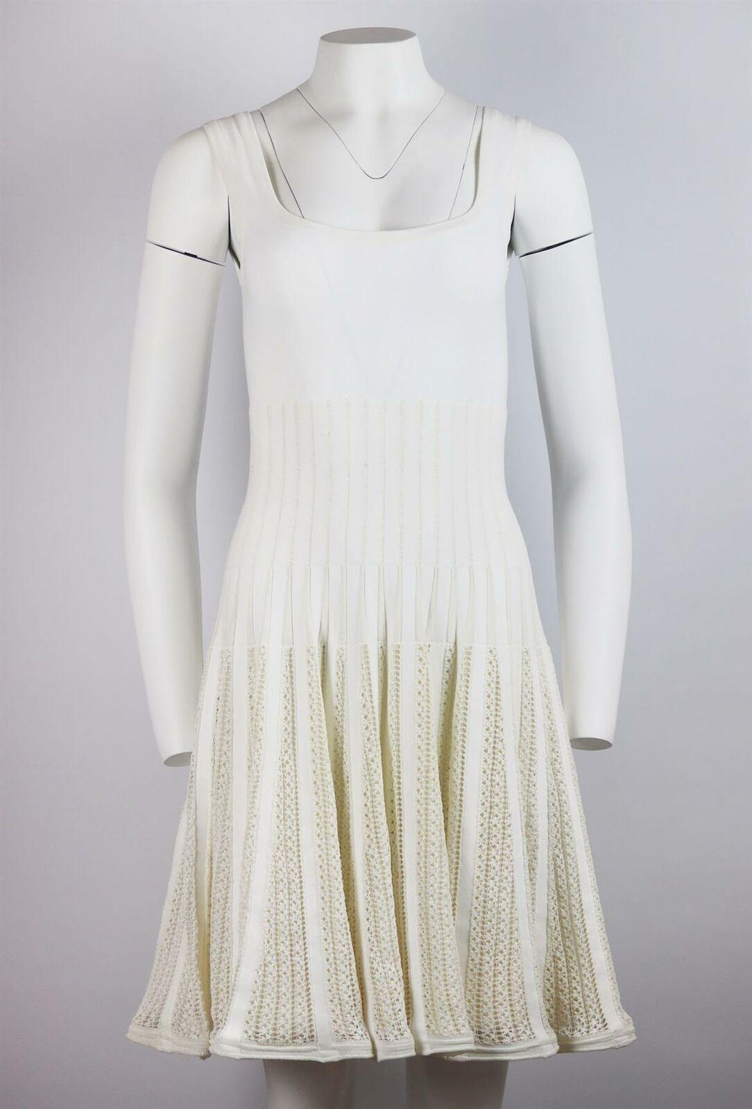 Azzedine Alaїa famously shunned fashion seasons and created beautiful, timeless collections instead this dress has been knitted by artisans in Italy, this cotton-blend mini dress is detailed with soft crochet on the swishy skirt.
White crocheted