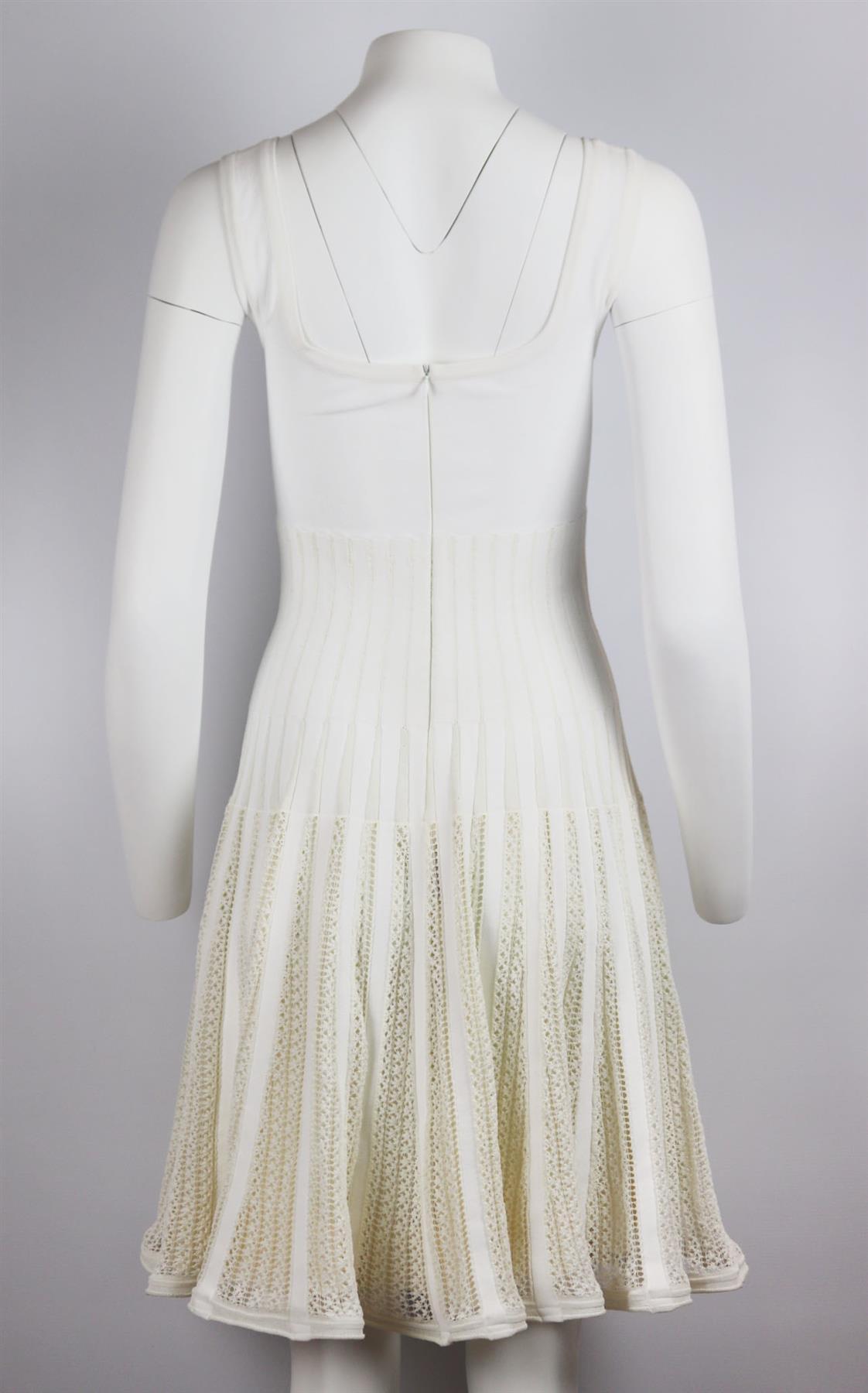 Azzedine Alaïa famously shunned fashion seasons and created beautiful, timeless collections instead – this dress has been knitted by artisans in Italy, this cotton-blend mini dress is detailed with soft crochet on the swishy skirt. White crocheted