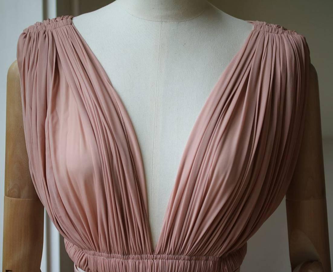 Dusty pink semi sheer ruched dress with cutout sides and elastic bands from Azzedine Alaia. Dress has a hidden bodysuit with zip/snap closure below skirt for modesty. Made in Italy. 

Size: FR 38 (UK 10, US 6, IT 42)

Condition: As new condition, no