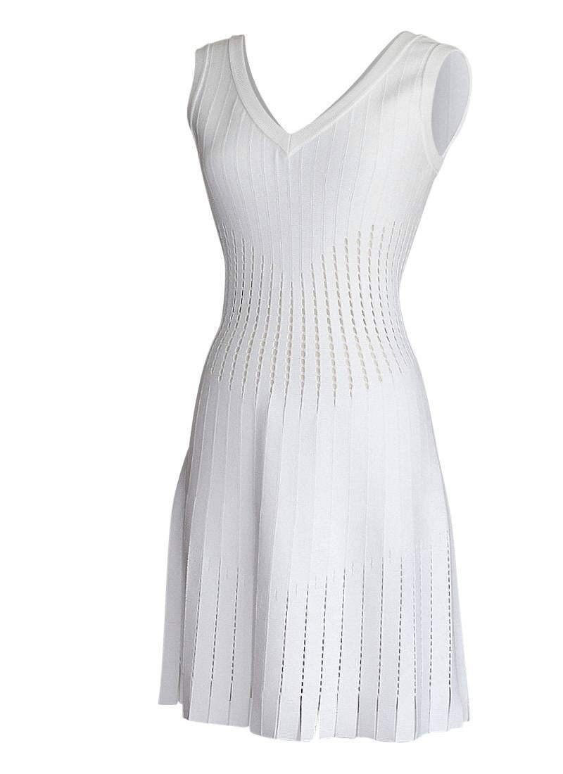 Azzedine Alaia exquisite white dress with cut out detail.
Sleeveless V neck.
Cut out pattern at waist repeats on skirt ending with a 2.25