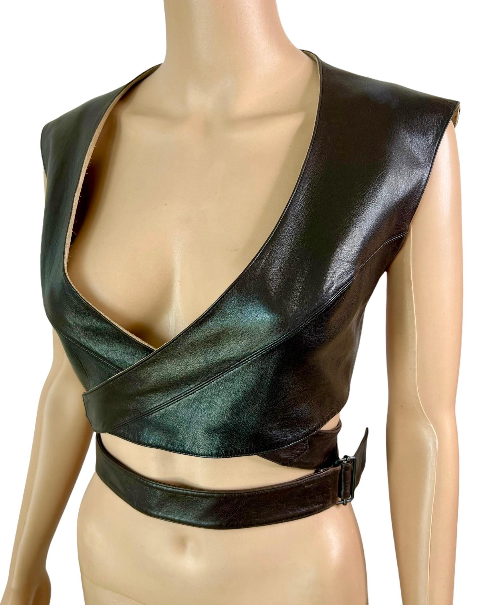 Azzedine Alaia F/W 1983 Vintage Leather Cutout Wrap Bra Crop Top FR 40

Azzedine Alaia vintage leather wrap bra top featuring wraparound design, belted at the waist for an adjustable fit.

