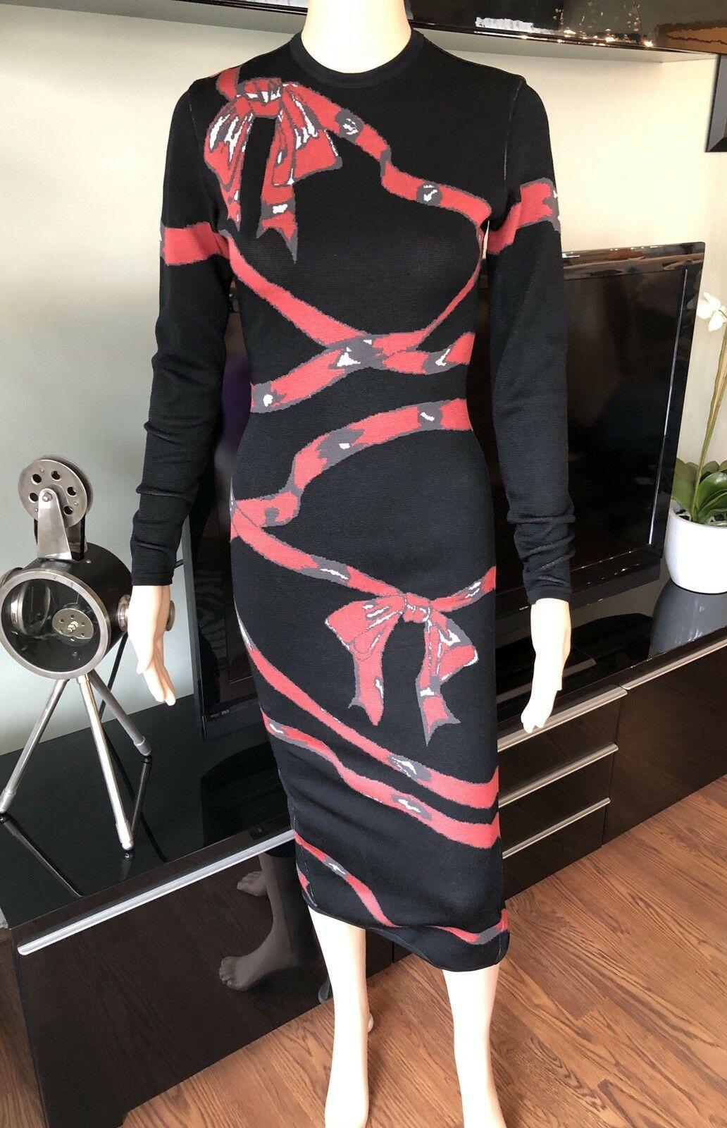 Azzedine Alaia Vintage F/W 1992 Runway Fitted Bow Ribbon Wrapped Dress Size Small

Alaïa long sleeve midi dress featuring bow print throughout, crew neck and concealed zip closure at back.

All Eyes on Alaïa
For the last half-century, the world’s