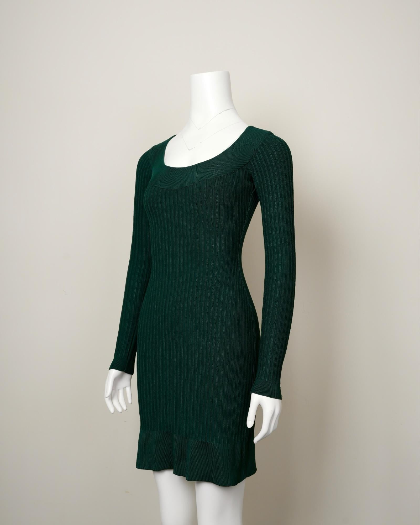 This ribbed knit green dress in Size L is a rare archival piece from Azzedine Alaïa’s Fall 1990 collection, a season defined by its tension between structured authority and seductive fluidity. Made from a luxurious blend of 93% rayon, 5% polyamide,
