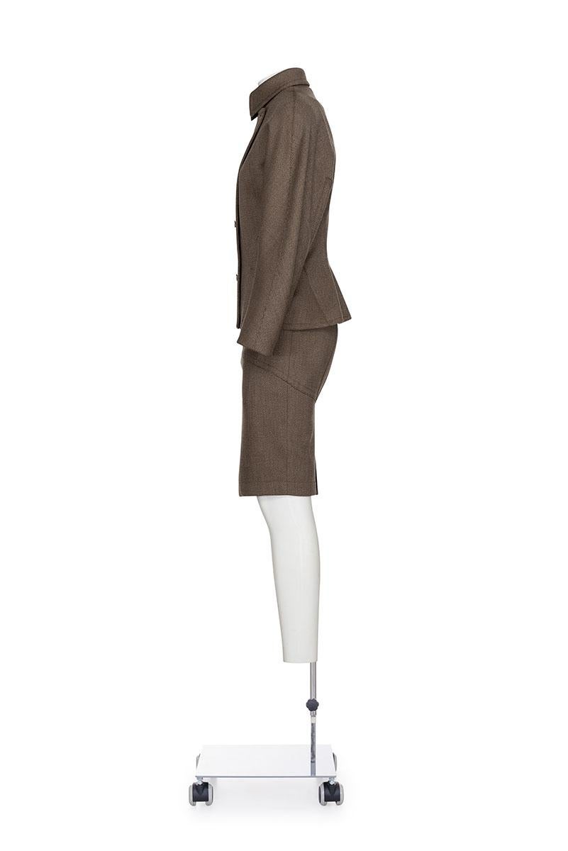 Fall Winter 1987 iconic and rare double breast suit in wool tweed by Azzedine Alaïa.
Rounded shoulders jacket with two pockets at front
Skirt with anatomical cuts and zipper at back
Fully lined 
The composition is 100% wool 

Jacket
Shoulder 44