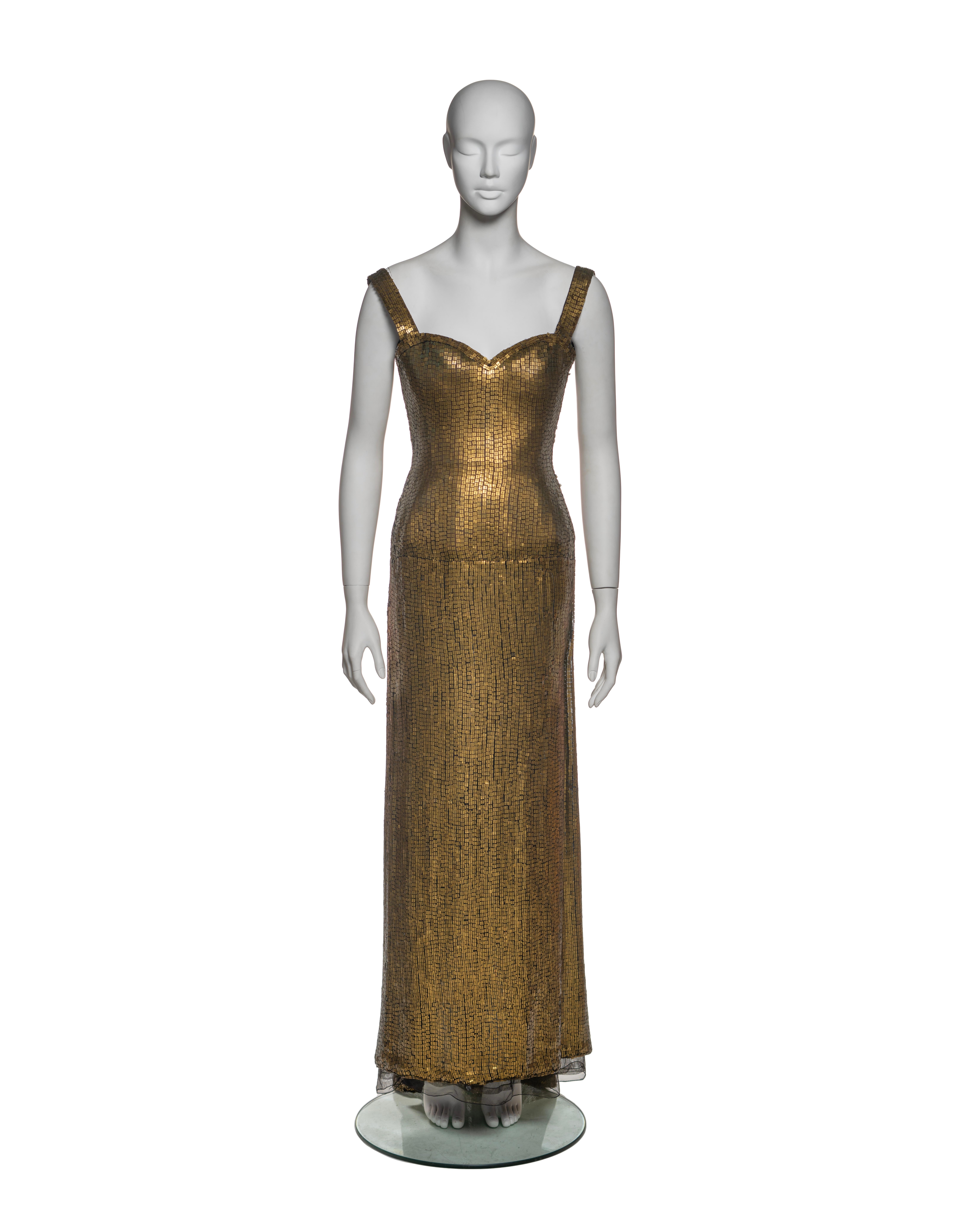 This rare, likely one-of-a-kind Azzedine Alaïa couture dress from the Fall-Winter 1990 collection is crafted from metallic gold lamé with a mosaic-like sequin overlay, creating a striking visual texture. The dress features a fitted bustier bodice