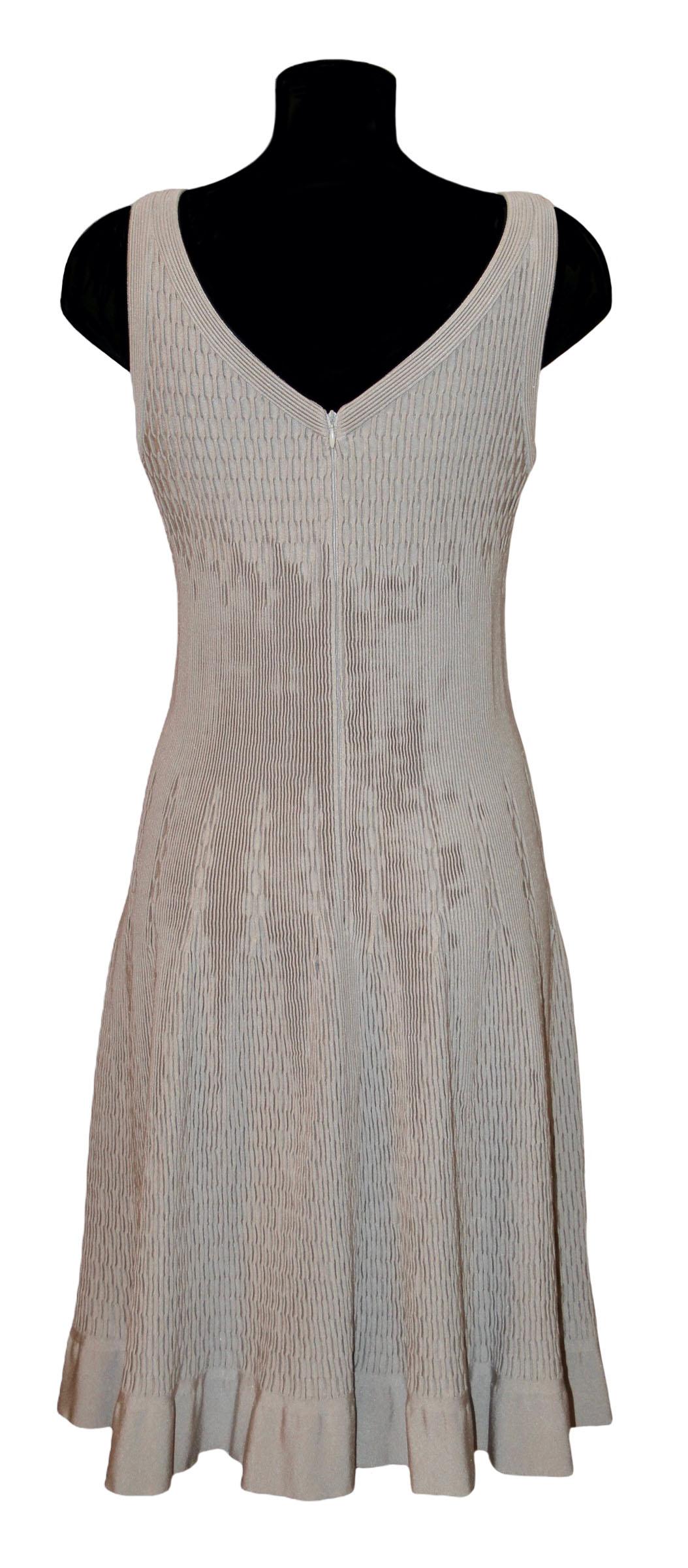 This pre-owned flare sleeveless dress from Azzedine Alaïa is a timeless shape and design.
It is crafted in a delicate greige color knit mesh fabric. The neckline is V-shape and the waist is fitted.

Fabric: 60% viscose, 25% nylon, 10% polyester, 5%
