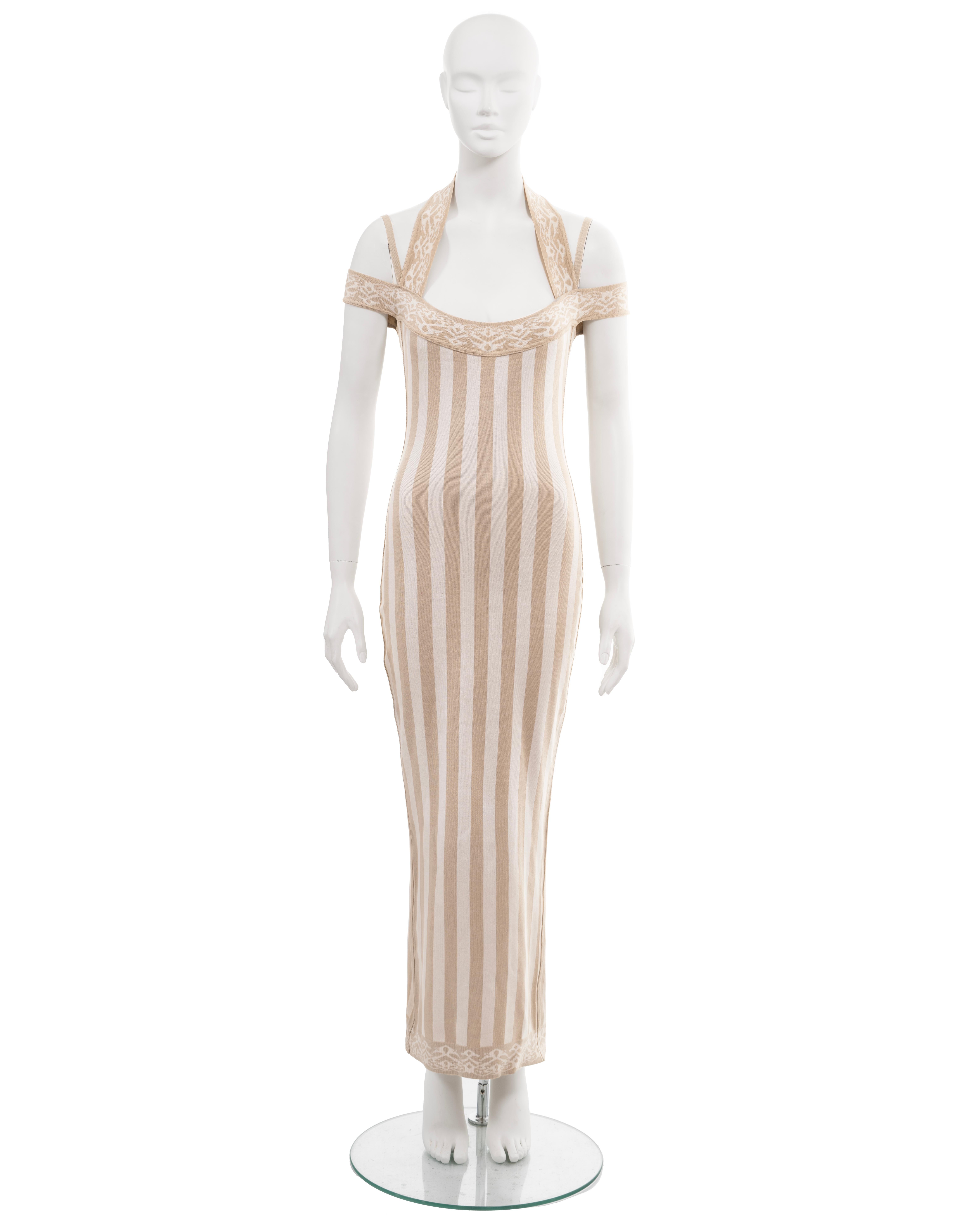▪ Archival Azzedine Alaia maxi dress
▪ Spring-Summer 1992
▪ Museum Grade
▪ Sold by One of a Kind Archive
▪ Constructed from a form-fitting cotton-nylon knitted jersey with vertical stripes in ivory and cream
▪ The trim showcases a repeated motif of