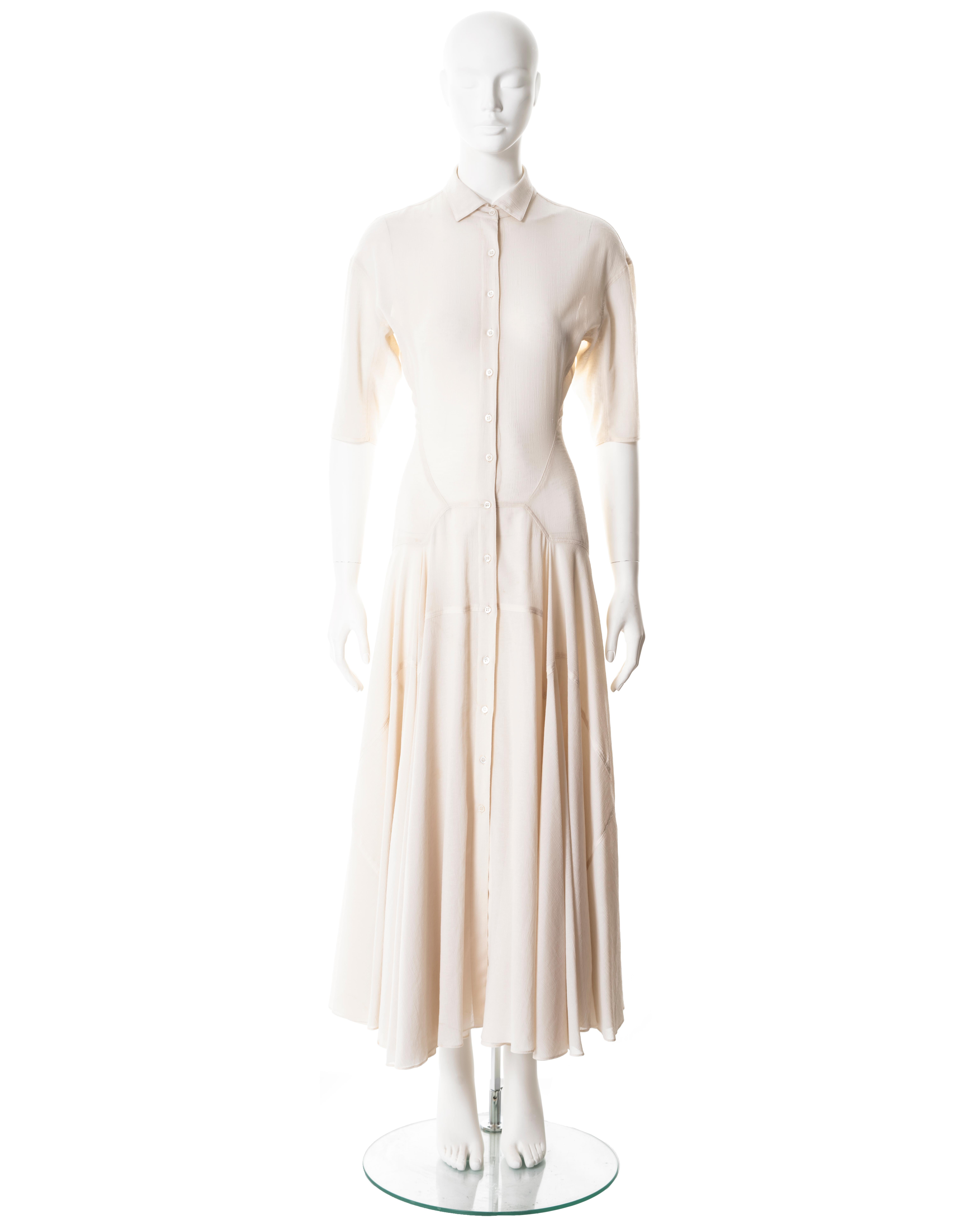 ▪ Azzedine Alaia button-up dress
▪ Sold by One of a Kind Archive
▪ Spring-Summer 1987
▪ Constructed from an ivory crinkled polyester 
▪ Classic shirt collar 
▪ Open front with button fastenings 
▪ Three-quarter length sleeves 
▪ Full ankle-length