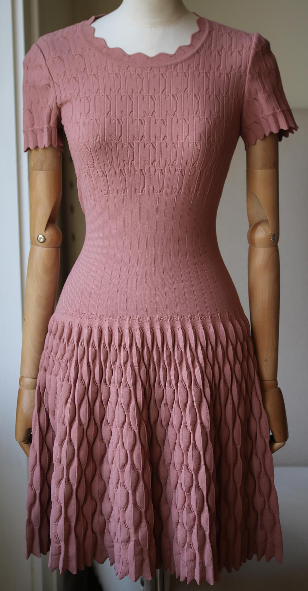 Defined corset-inspired waists are an Alaïa signature. This dress is hand-finished from a knitted fabric that has been developed by experts in Italy - it is unique to the brand and has a beautiful three-dimensional quality. Antique-rose