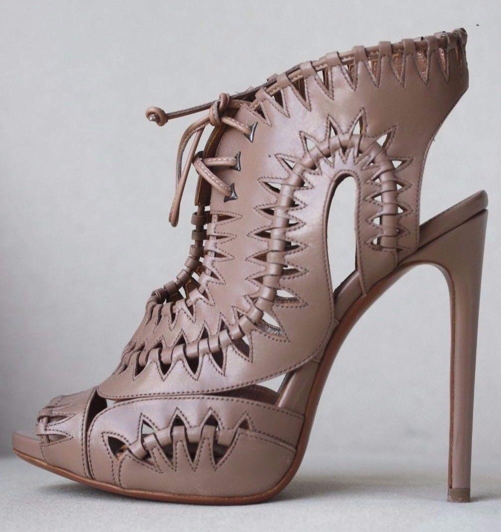 Alaïa grecian-inspired sandals have been made in Italy from taupe leather with woven cutouts and a dramatic lace-up front. 
Heel measures approximately 110 mm/ 4.5 inches. 
Taupe leather. 
Lace up front. 
Does not come with a box or dustbag. 

Size: