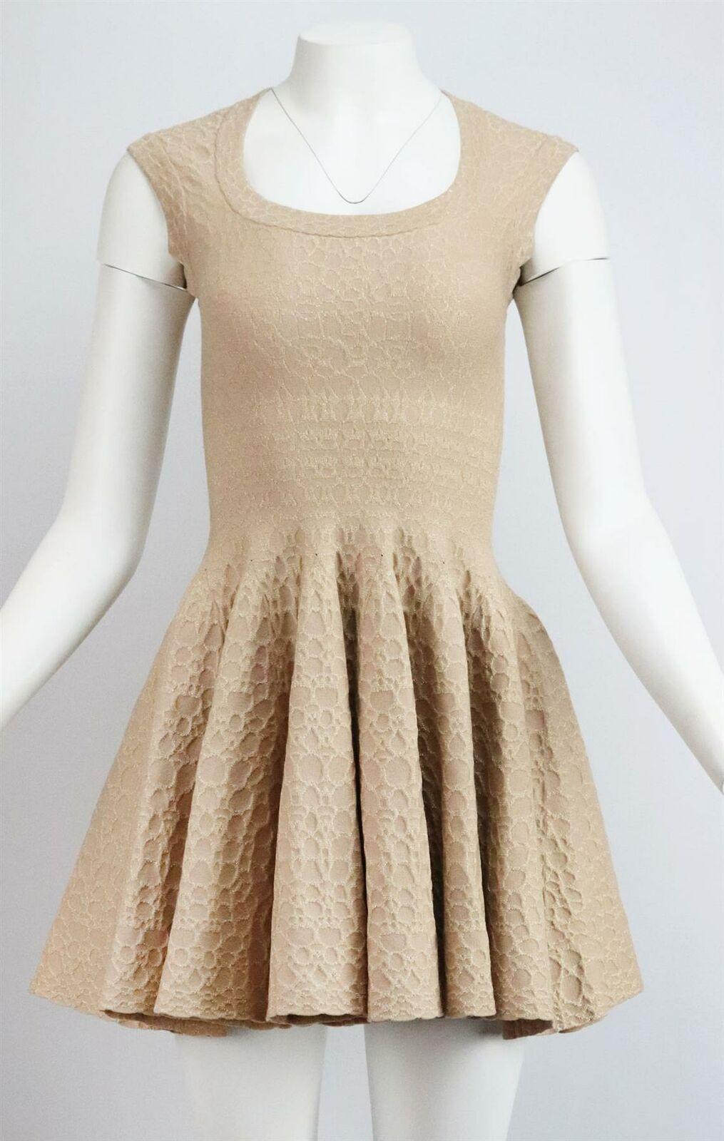 The weighted, stretch-knit of Alaїa's mini dress ensures the skater silhouette holds its shape, patterned with metallic jacquard design, this style has a scoop-neck and is sleeveless.
Metallic beige wool-blend.
Concealed zip fastening at back.
45%