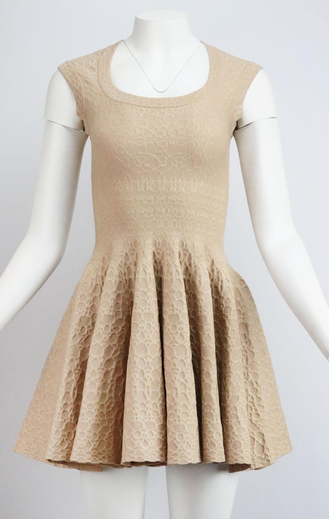 The weighted, stretch-knit of Alaïa's mini dress ensures the skater silhouette holds its shape, patterned with metallic jacquard design, this style has a scoop-neck and is sleeveless. 
Metallic beige wool-blend. 
Concealed zip fastening at back.
45%