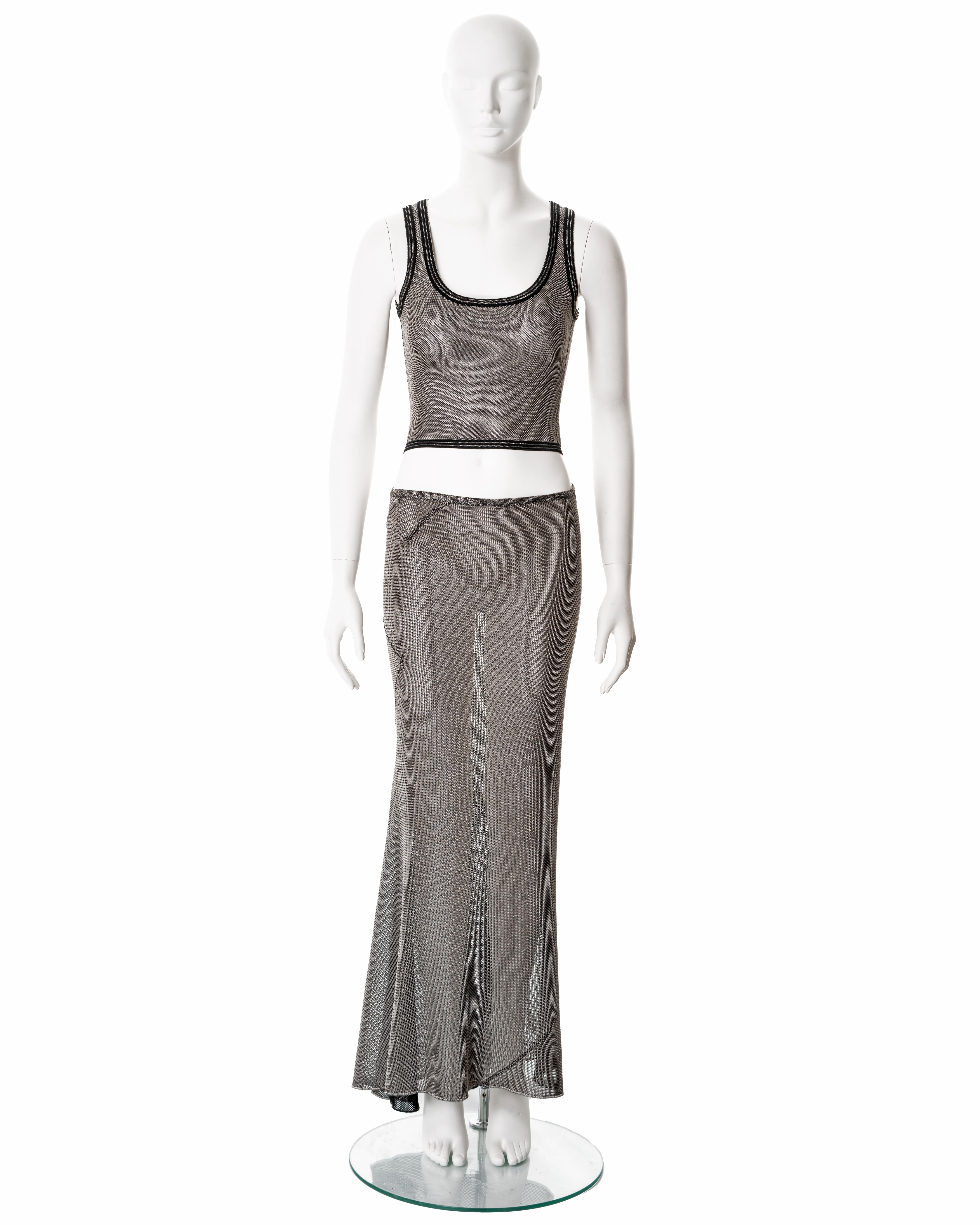 ▪ Azzedine Alaia 2-piece 
▪ Sold by One of a Kind Archive
▪ Fall-Winter 2001
▪ Constructed from metallic silver lurex knit 
▪ Cropped scoop-neck tank
▪ Bias-cut maxi skirt 
▪ Size 'XS'
▪ Made in Italy  

All photographs in this listing EXCLUDING any