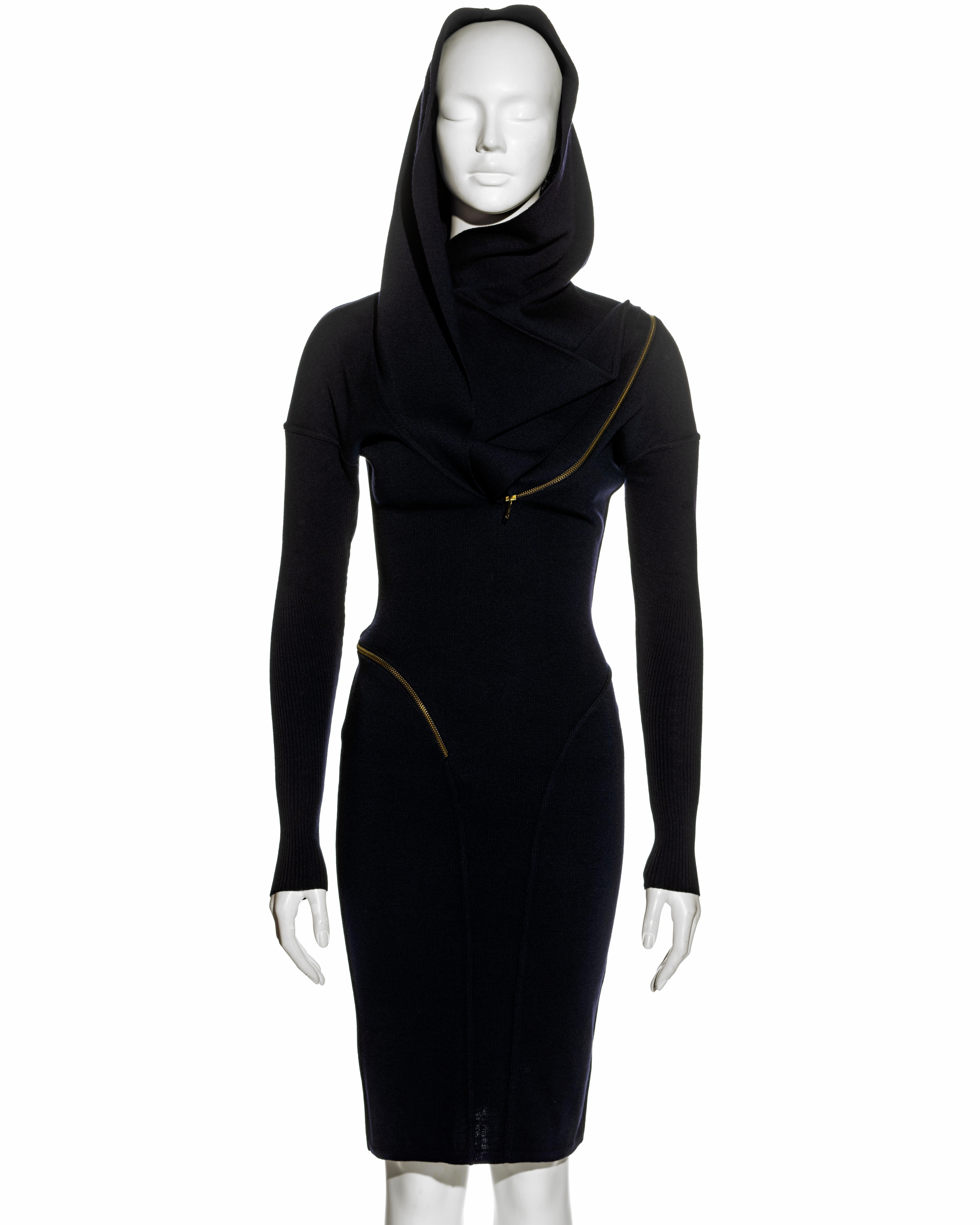 ▪ Azzedine Alaia knitted virgin wool dress
▪ Single zip fastening circles the body starting at the right hip and ending at the left breast
▪ Integral hood with scarf ending on one side closing with a snap button
▪ Knee-length skirt 
▪ Long sleeves
▪