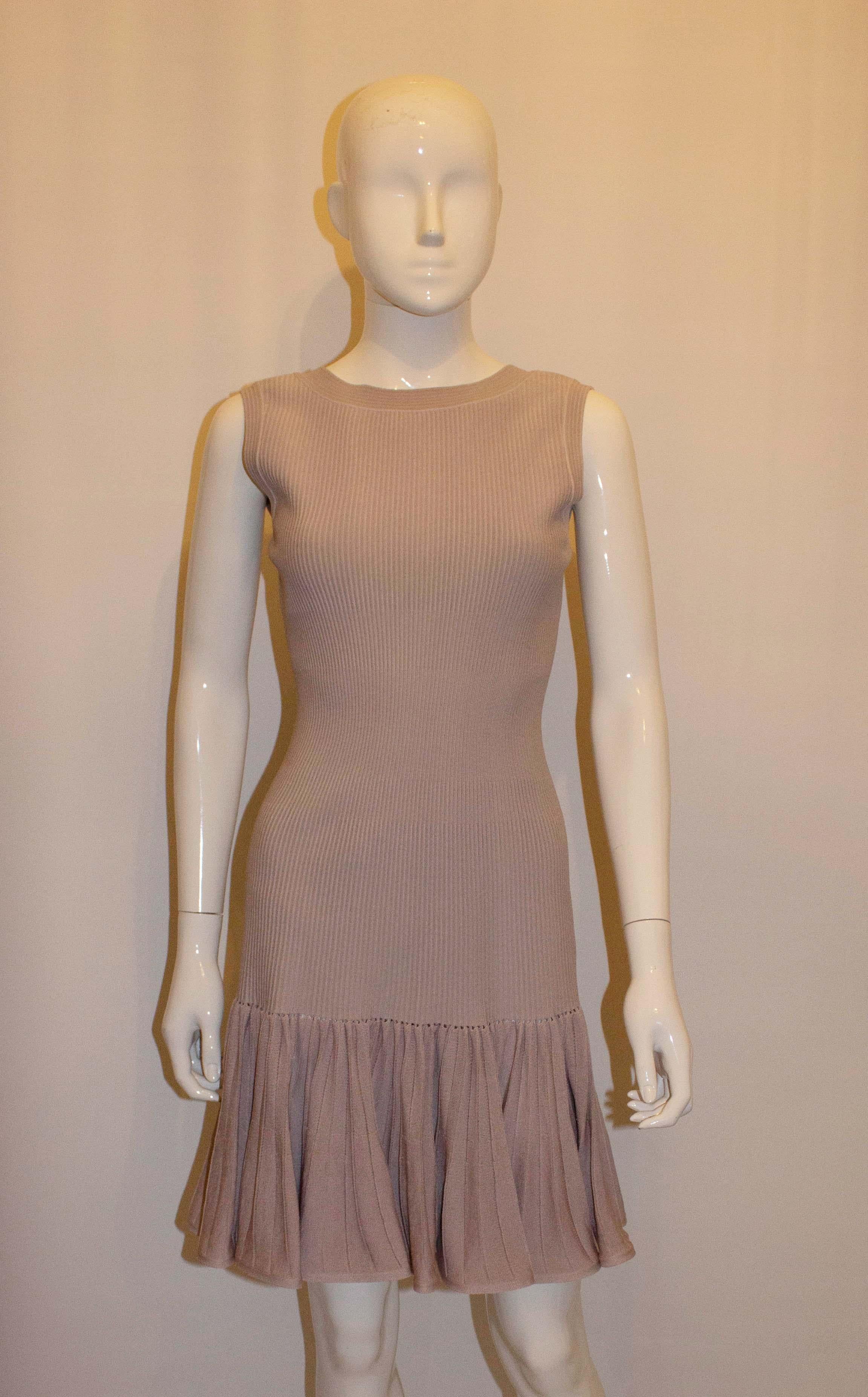 A pretty and chic dress by Alaia , Paris . In a silk mix the dress has a drop waist, round necklline and v backline. It has a central back zip. Made in Italy. Size 44 Bust 36'' , length 37''