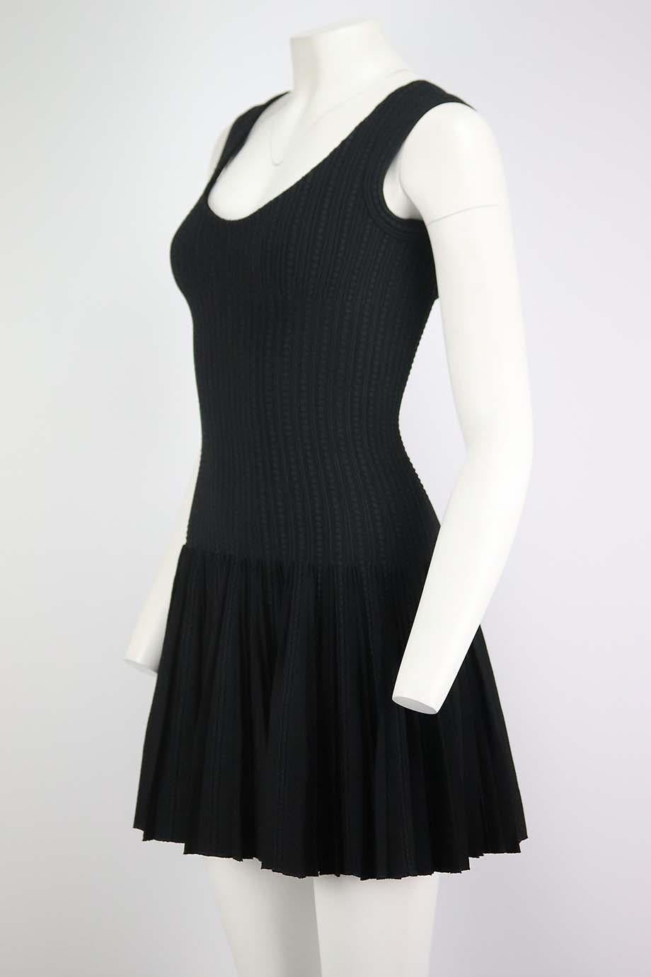 This mini dress by Azzedine Alaïa is designed in a figure-skimming skater silhouette, this sleeveless style is made from stretch-knit and trimmed with textured edge. Black viscose-blend. Zip fastening at back. 62% Viscose, 14% silk, 14% polyester,