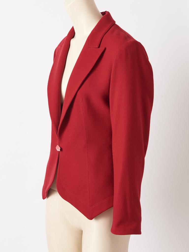 Azzedine Alaia, brick red, wool crepe, multi-seamed, fitted jacket having a sculpted silhouette, with side slits, a curved back hem, and a pointed front  hem with mitered corners.