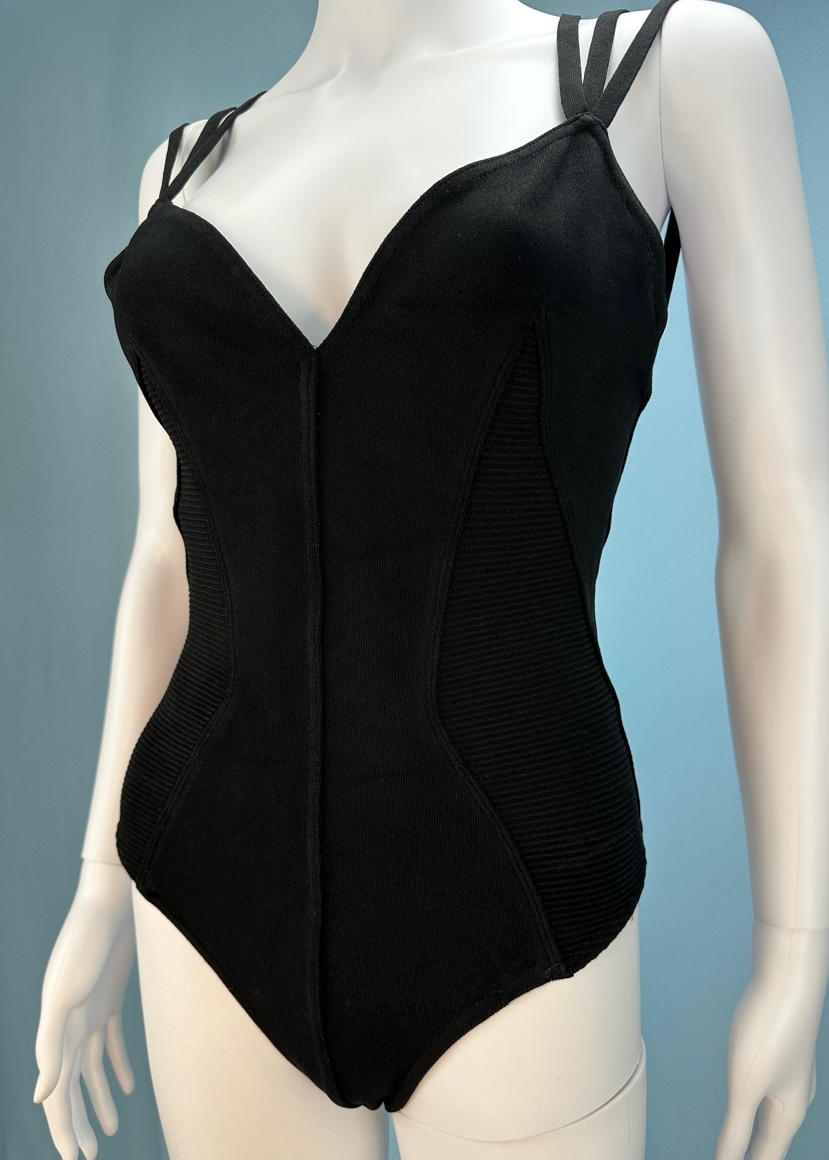 Vintage Azzedine Alaïa

Spring 1990 - dress version seen on the runway 

Black bodysuit with triple strap detail

Ribbed texture on sides 

Popper clasp

Stretch fabric 

Size small - fits approx UK 6 - 10 / US 10 - 14 due to stretch 