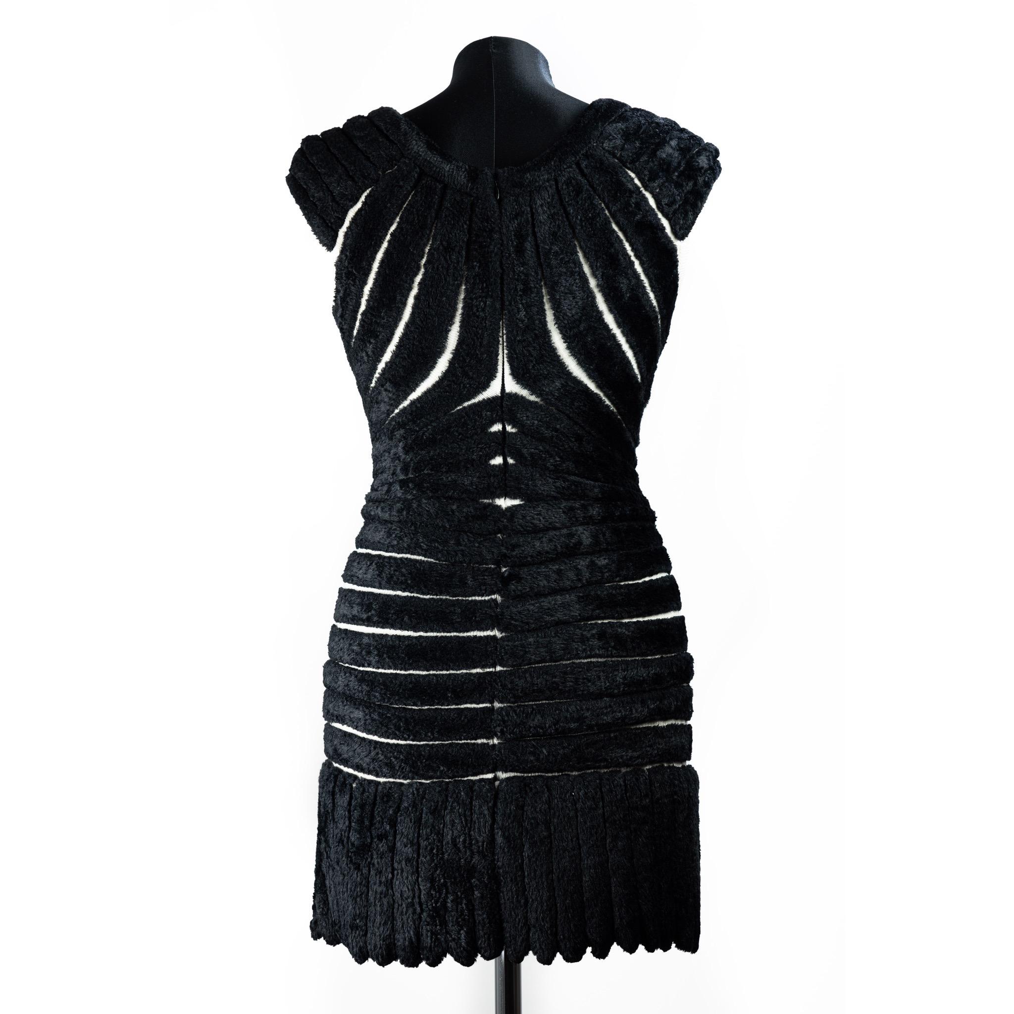 Azzedine Alaia black chenille knitted 'houpette' mini dress. Sculpted figure-hugging design with concentric chenille bands.
From Spring Summer 1994 collection.
Made in in a fluffy chenille or Houpette to resemble swans down. Featuring a panels of