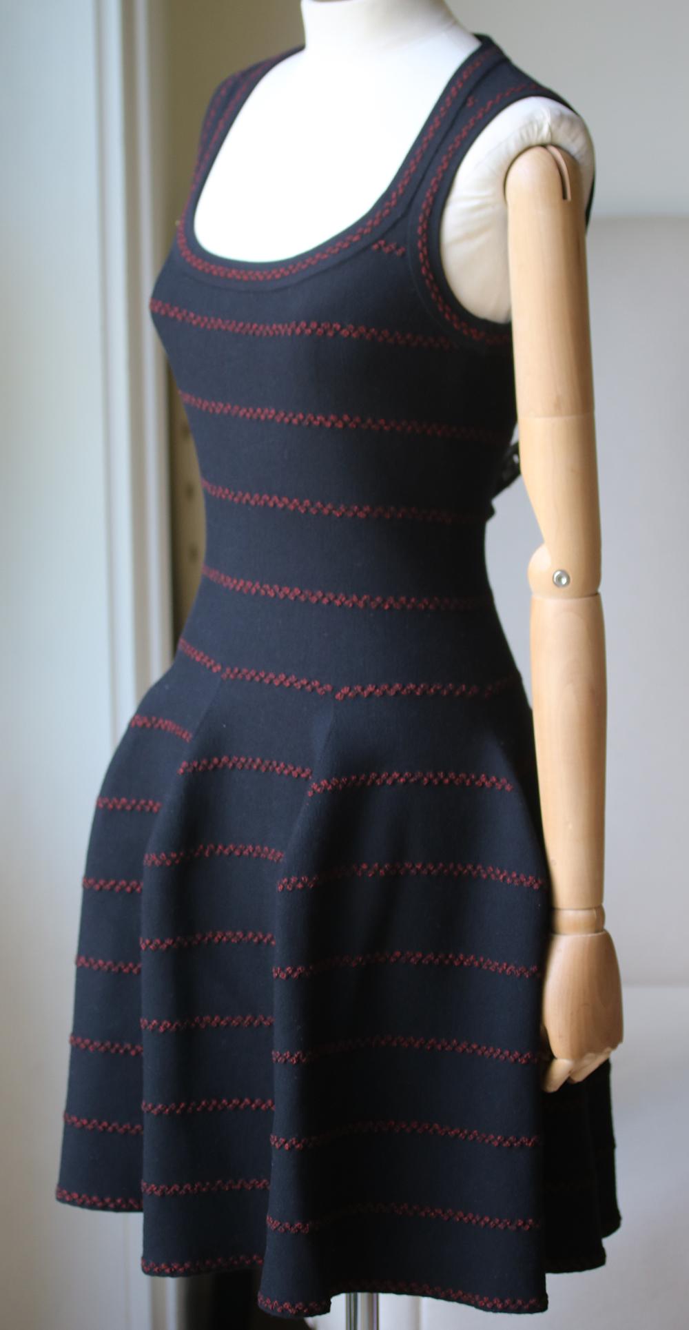 Stretch-knit dress from Azzedine Alaïa. All over textured burgundy metallic stripe dot print. Zip-up back fastening. Sleeveless. Fitted waist leads to a fluted skirt. Unlined. 45% Viscose, 35% wool, 15% polyester, 5% polyamide. Comes up