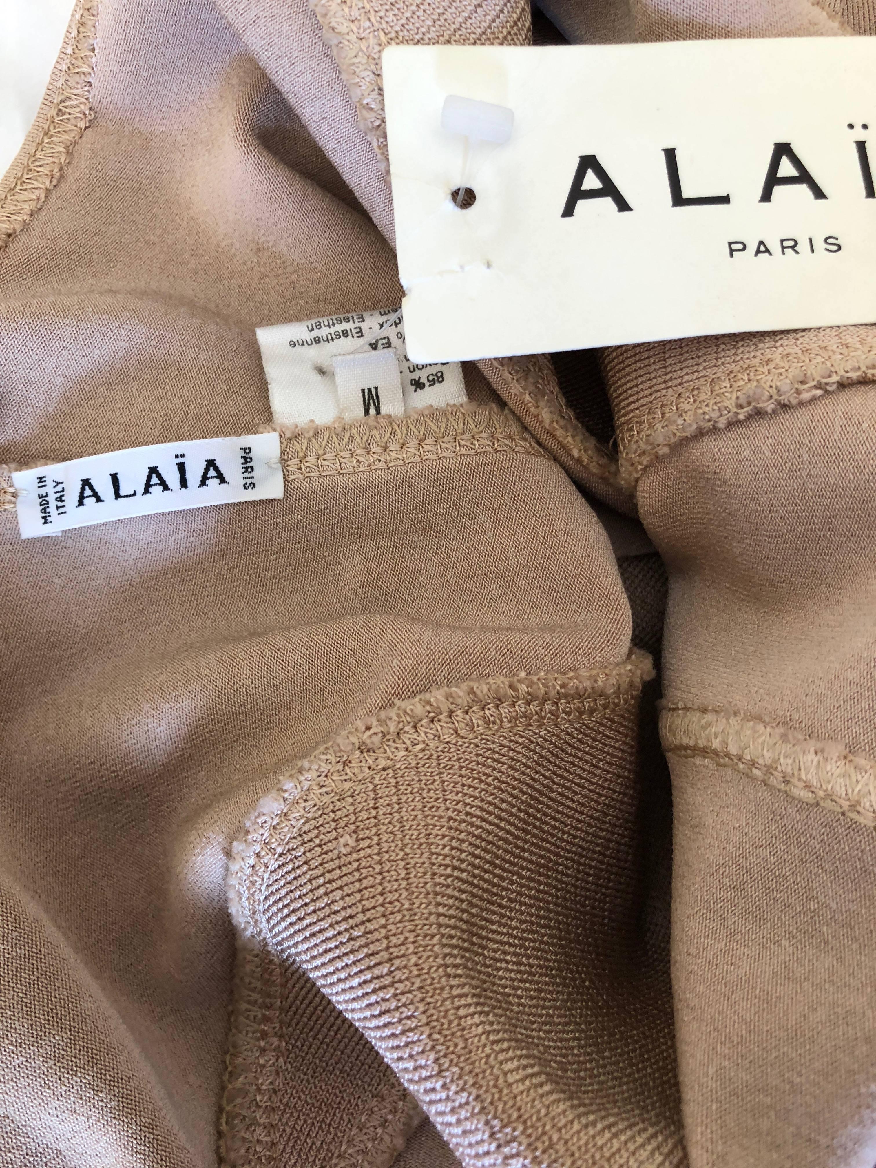 Azzedine Alaia Sexy Tan Vintage 1980's Cross Back  Dress with  Inserts
 Deadstock , unworn NWT 
  There is  a lot of stretch
There are two Alaia's from this collector, both purchased in the eighties and never worn.
Please see all the great 80's