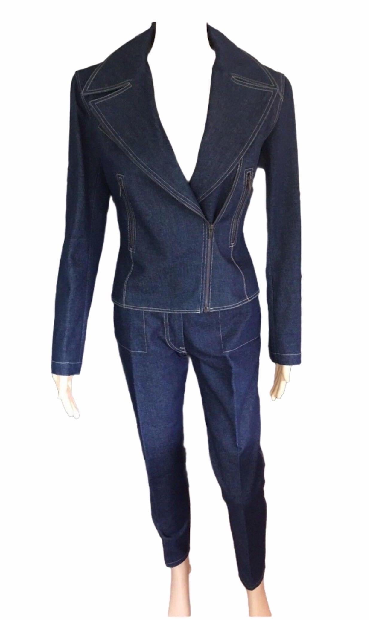 Alaïa denim 2 piece pantsuit. Jacket features notched lapels, three zip-accented pockets at front, lace-up accents at back and zip closure at front. Pants feature four pockets, contrast stitching throughout and zip closure at front. Excellent