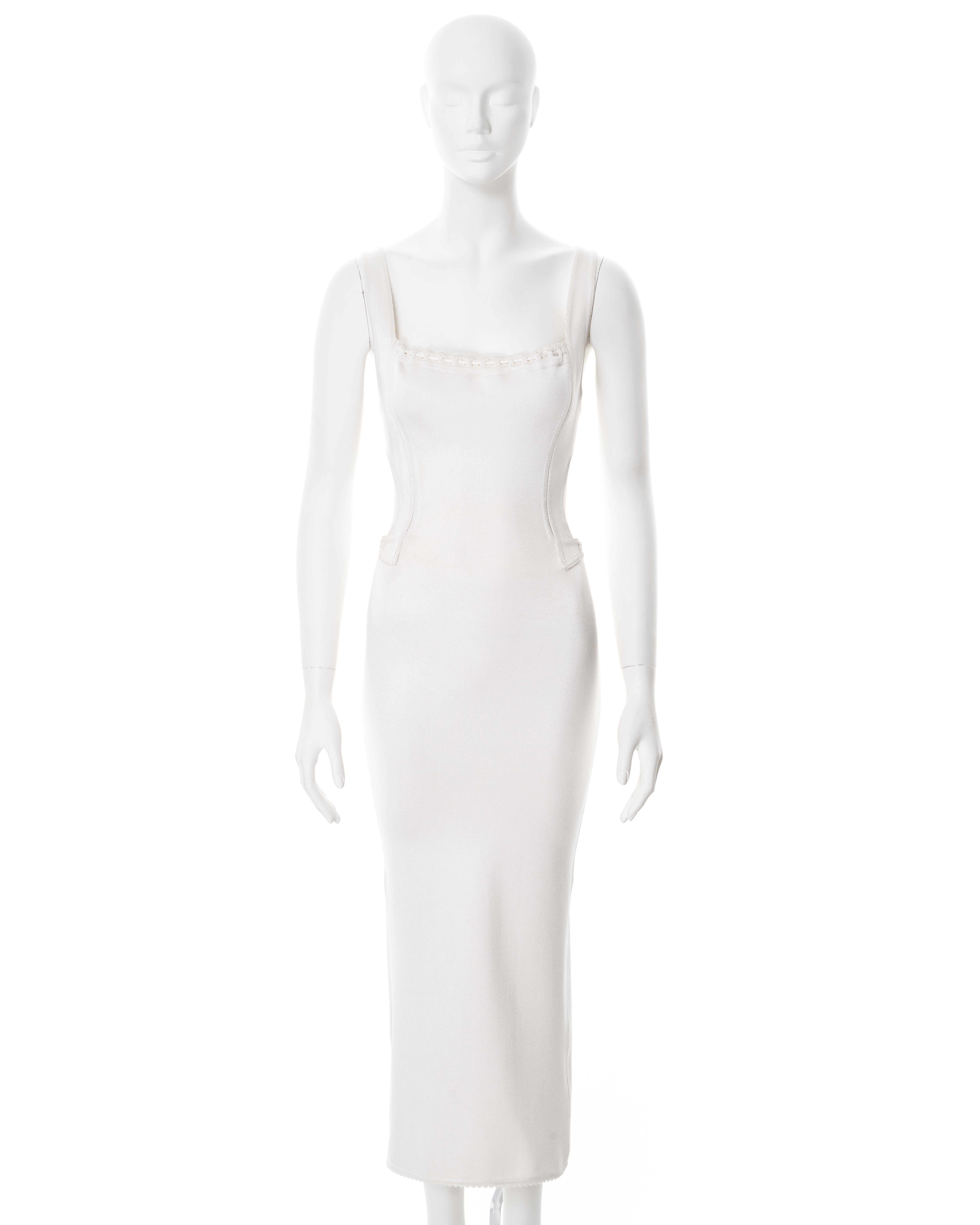 ▪ Azzedine Alaia bodycon dress
▪ Sold by One of a Kind Archive
▪ Spring-Summer 1993
▪ Constructed from white jersey comprising viscose, spandex and nylon 
▪ Open back and sides 
▪ Bodice with bra-style straps 
▪ Calf-length flared skirt 
▪ Size