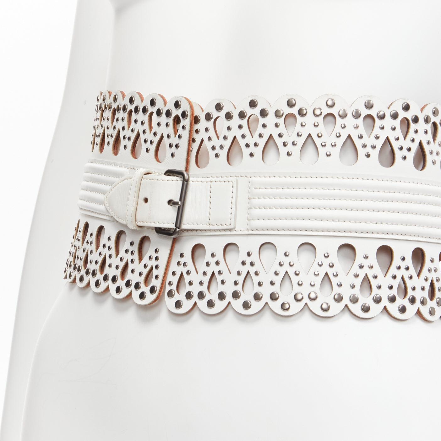 AZZEDINE ALAIA white laser cut studded leather corset waist belt 70cm
Reference: BSHW/A00139
Brand: Alaia
Designer: Azzedine Alaia
Material: Leather
Color: White, Metallic
Pattern: Solid
Closure: Belt
Lining: Beige Leather
Made in: