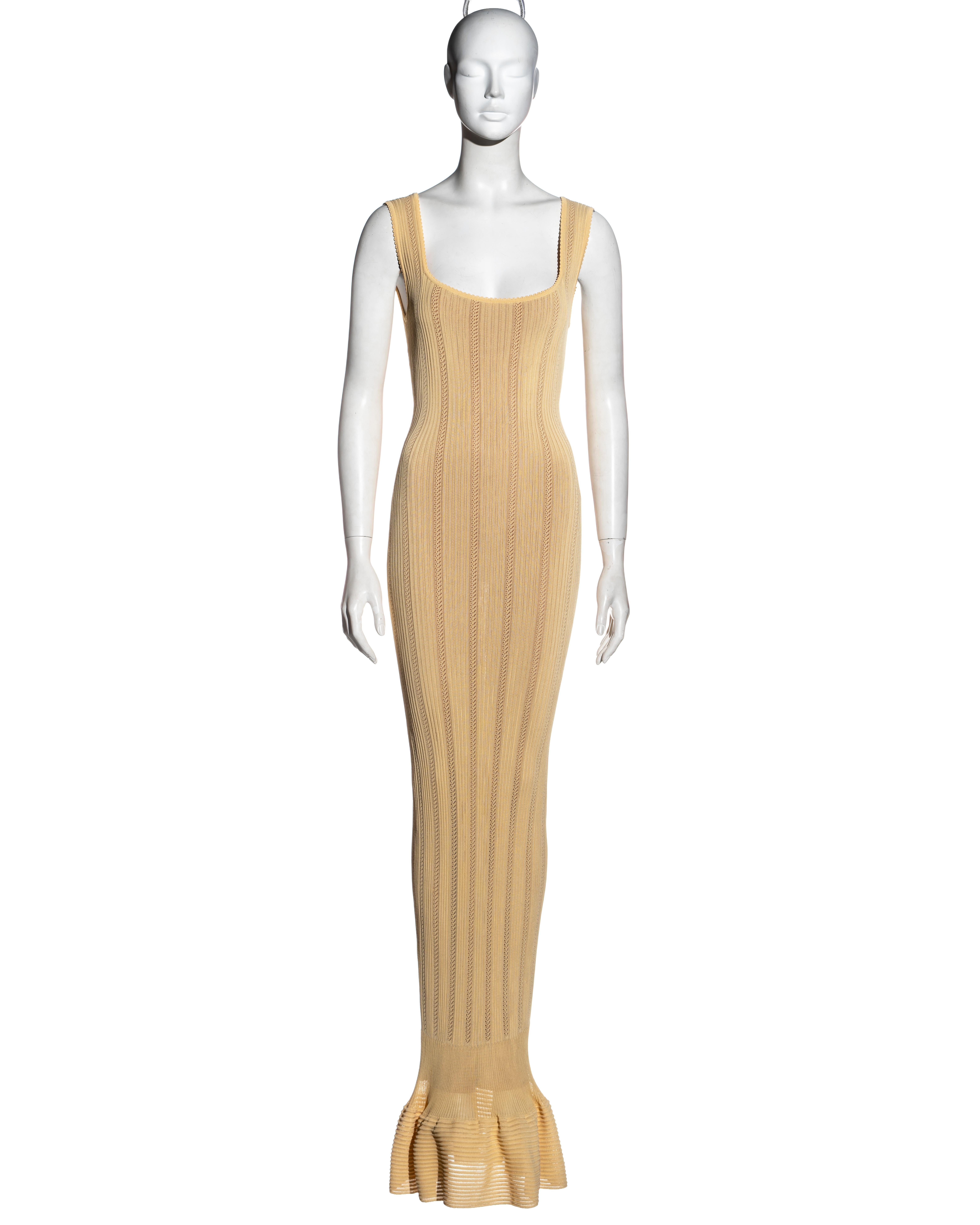 ▪ Azzedine Alaia yellow rayon floor-length dress
▪ Stretch open-knit 
▪ Fishtail skirt 
▪ Figure hugging fit 
▪ Nude lining 
▪ Size 'S'
▪ Spring-Summer 1996
▪ 100% Rayon
▪ Made in Italy