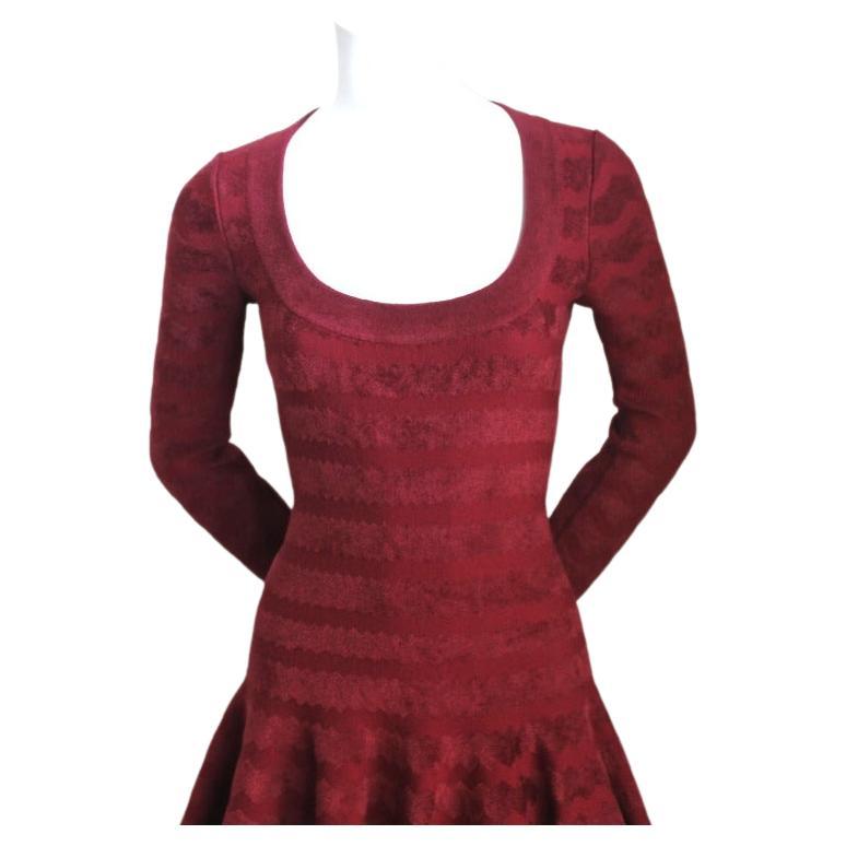 Cranberry, chenille knit dress with woven zig- zag pattern from Azzedine Alaia. Labeled a French size 38 which would best fit a US 4 or 6. Zips up center back. Made in Italy. New with tags.