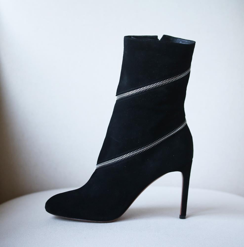 Alaïa's edgy suede boots have a fully functioning zip fastening that wraps around the front and ankle. Heel measures approximately 90mm/ 3.5 inches.  Black suede. Zip fastening along ankle and front. Does not come with a box.  

Size: EU 38 (UK 5,