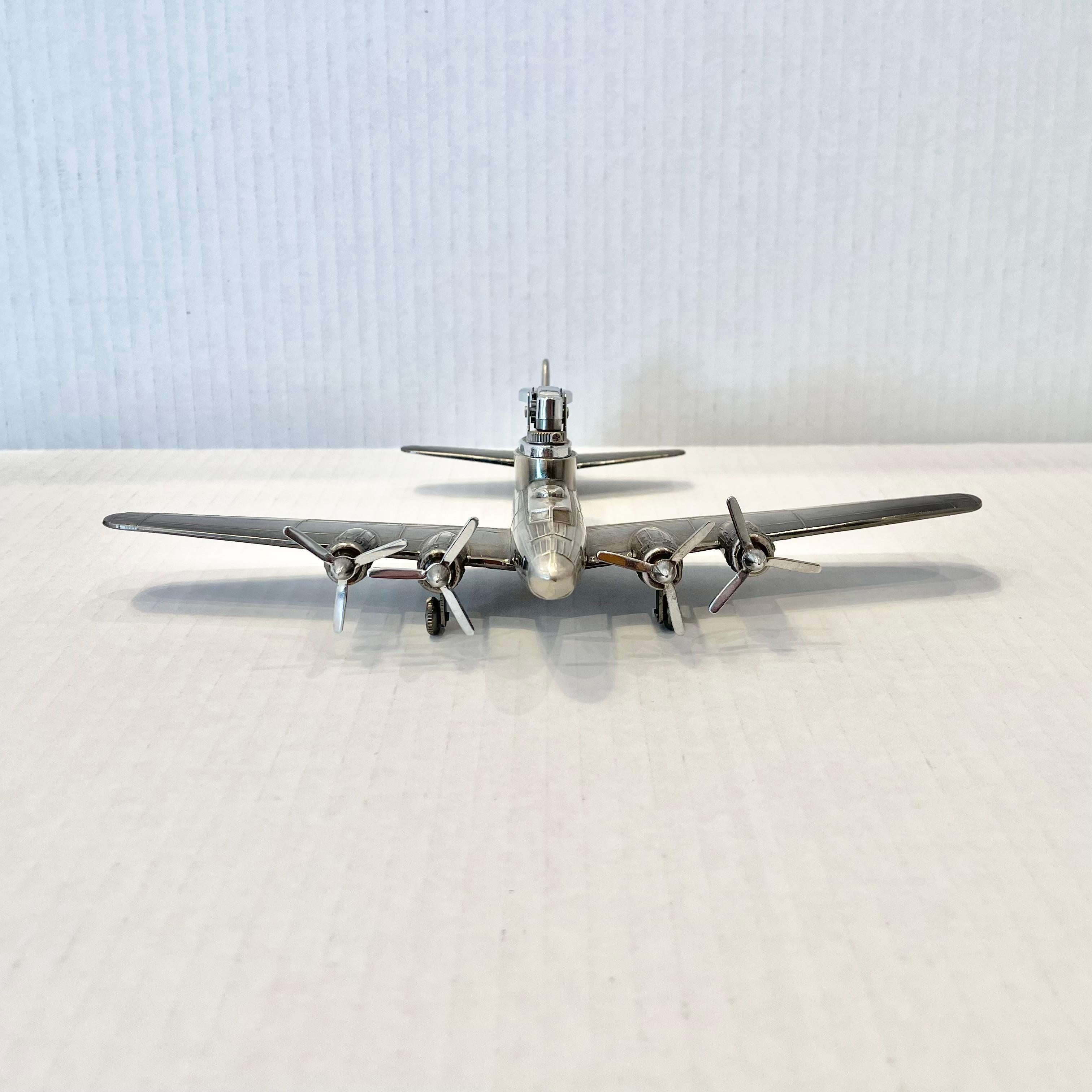 Cool vintage table lighter in the shape of a B-17F bomber plane. Made completely of metal with a hollow body. Beautiful burnished silver color with intricate details. Cool tobacco accessory and conversation piece. Working lighter. Very unusual